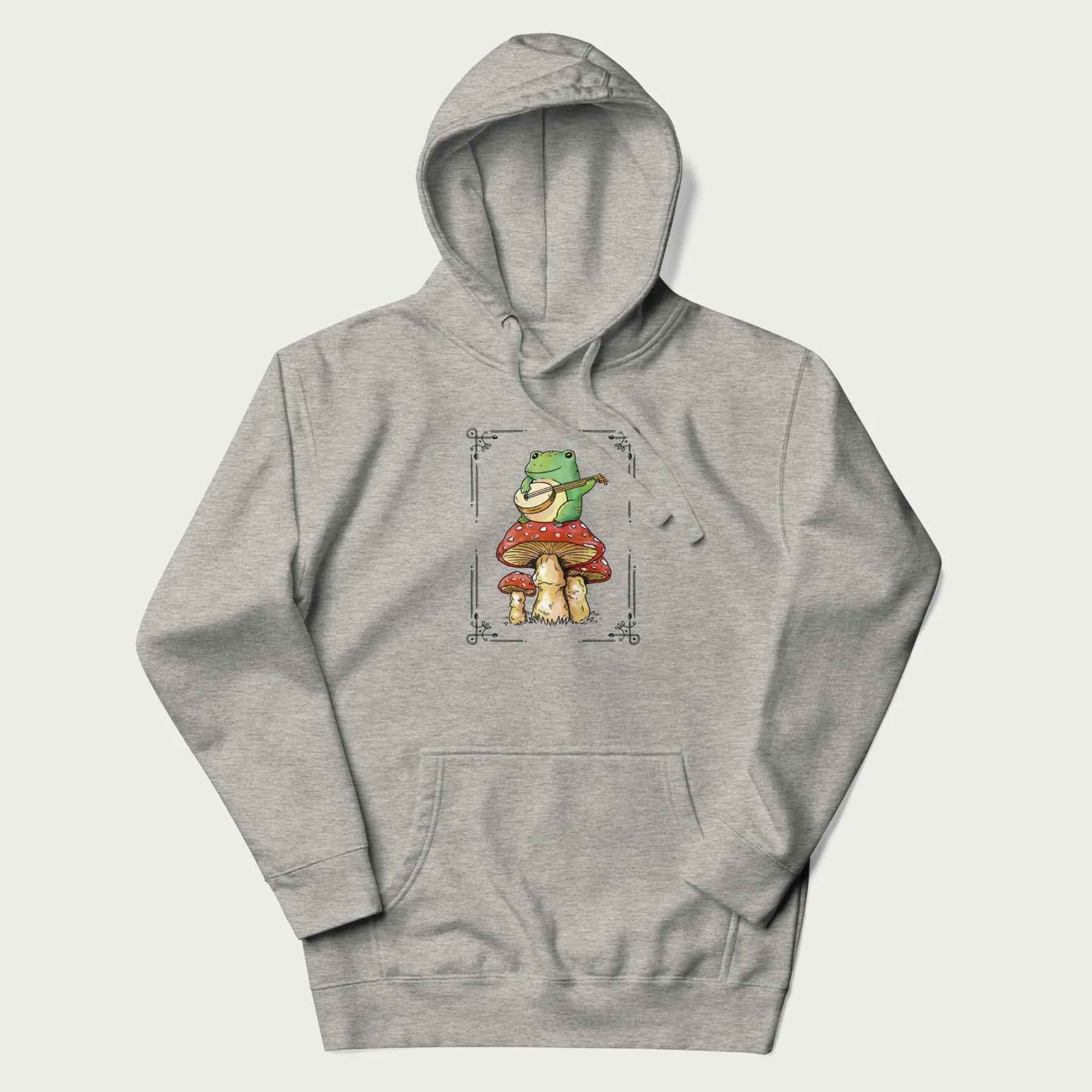 Light grey hoodie featuring a graphic of a frog playing a banjo on top of red mushrooms.