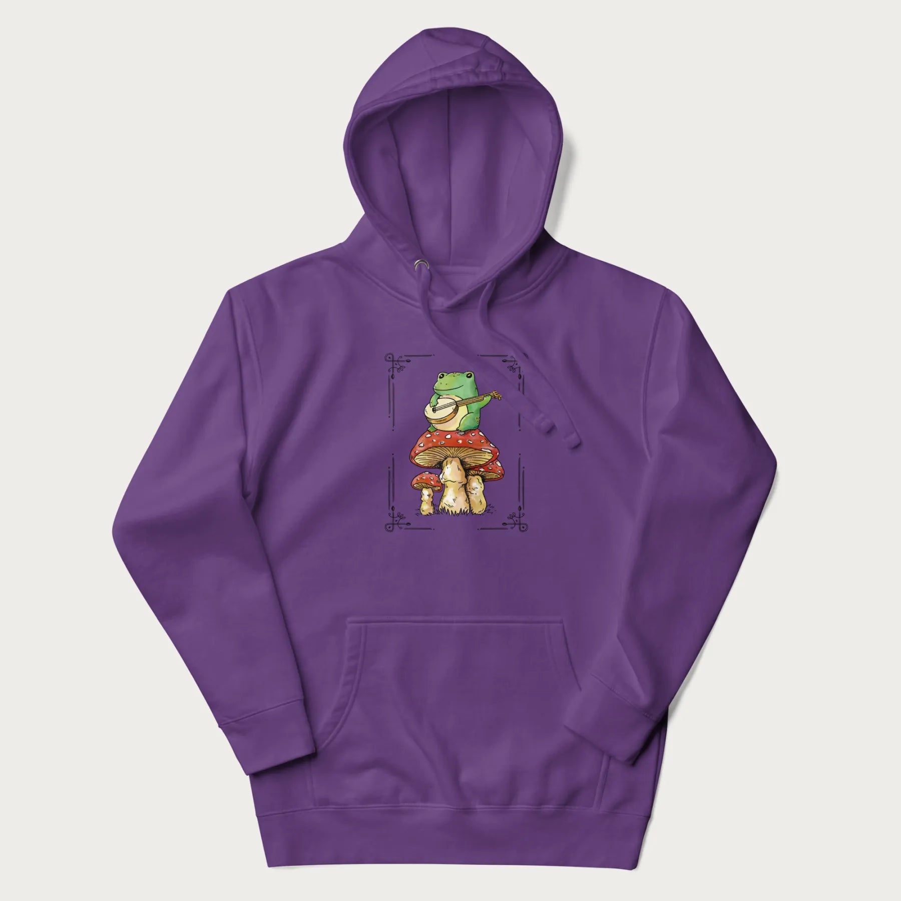 Purple hoodie featuring a graphic of a frog playing a banjo on top of red mushrooms.