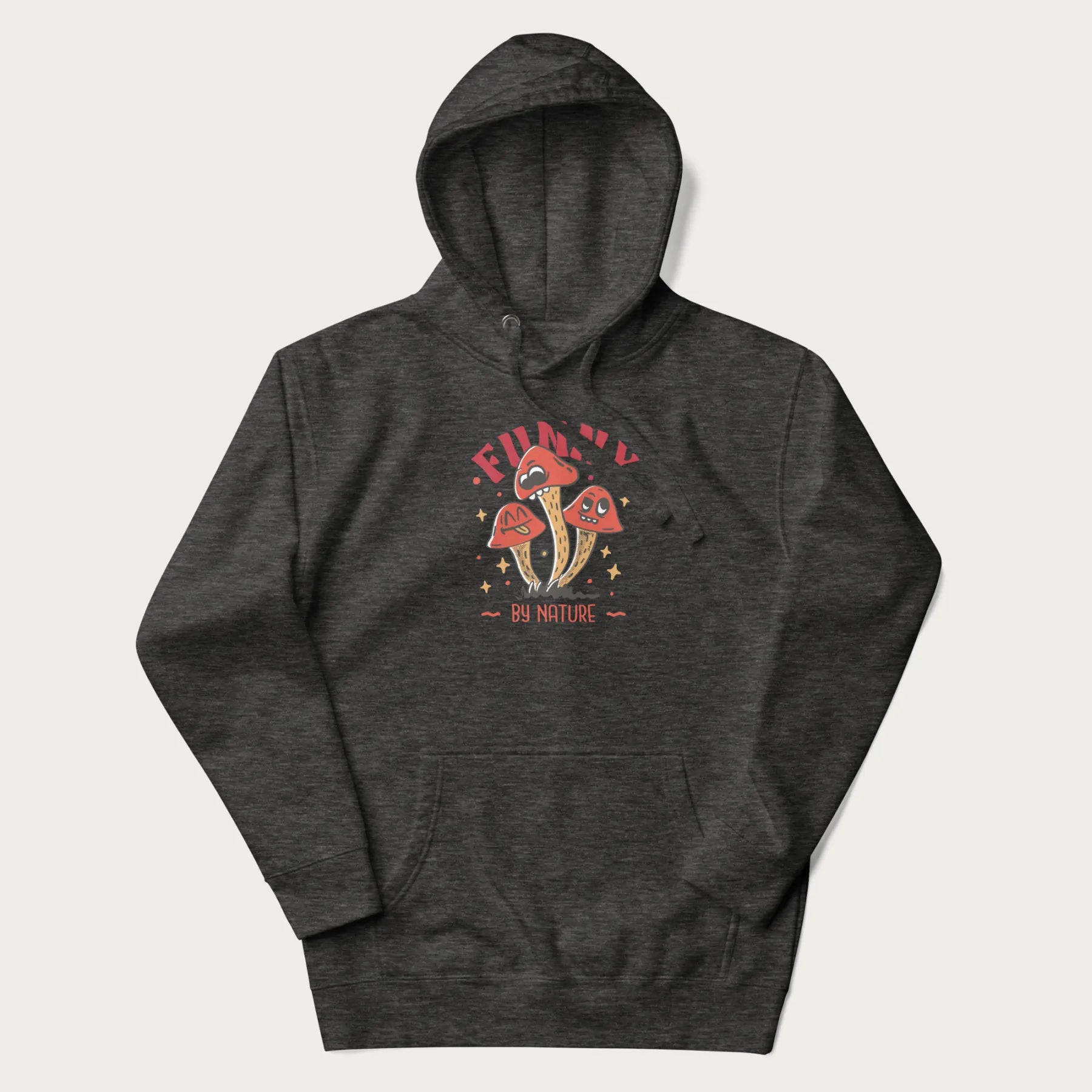 Dark grey hoodie featuring a playful graphic of three mushrooms with expressive faces and the text "Funny by Nature."