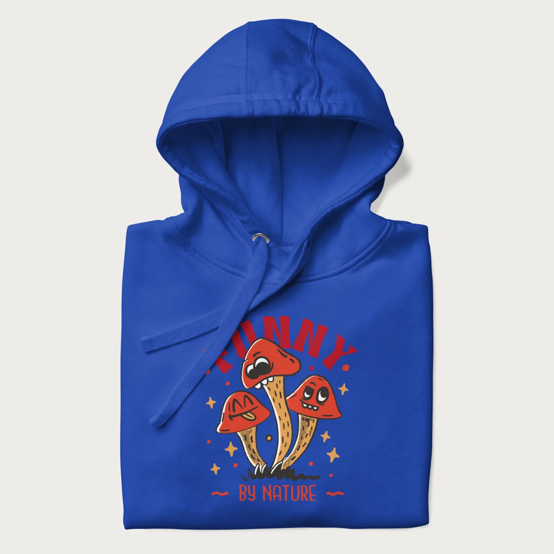 Folded royal blue hoodie featuring a playful graphic of three mushrooms with expressive faces and the text "Funny by Nature."