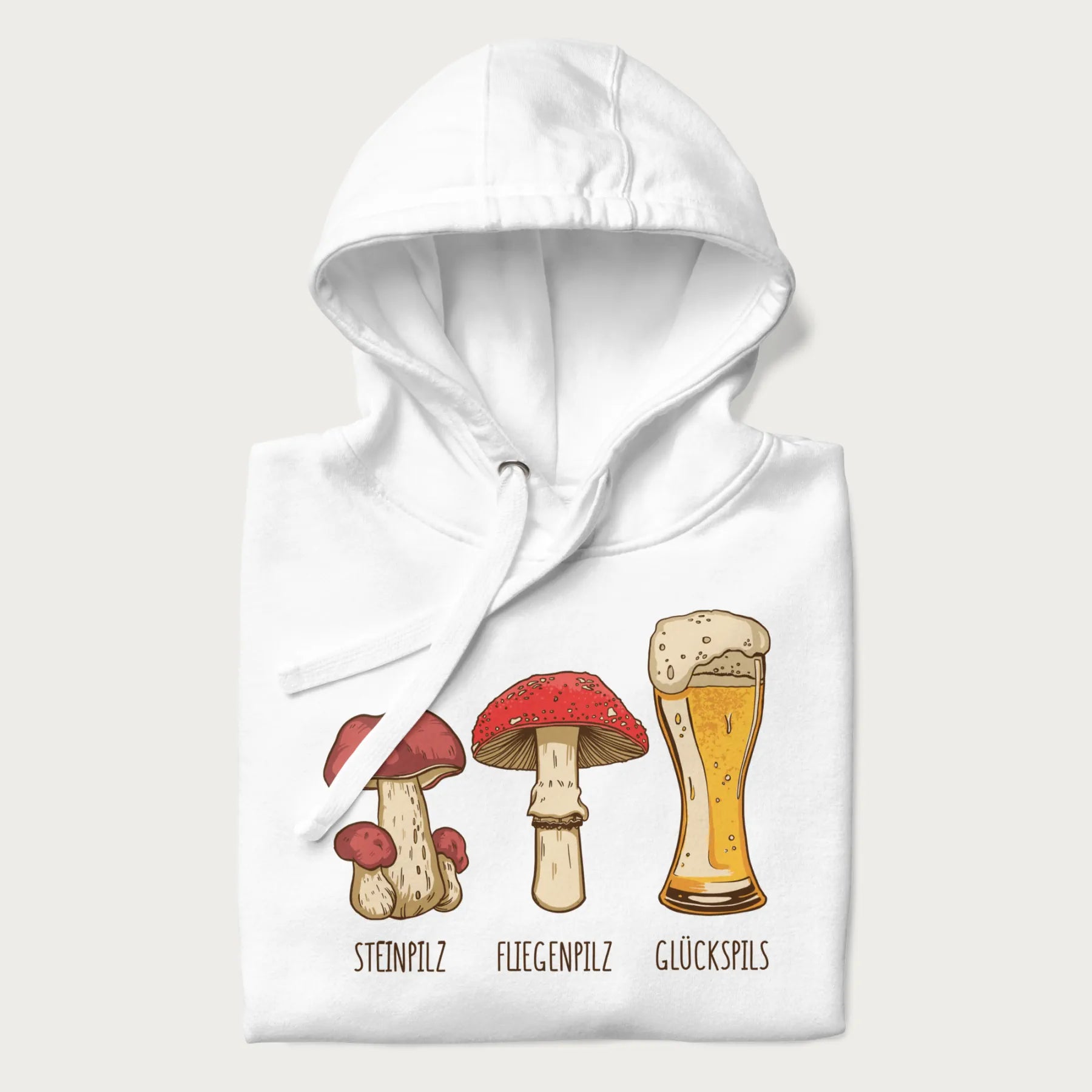 Folded white hoodie with illustrations of a Steinpilz, Fliegenpilz, and a beer glass labeled Glückspils.