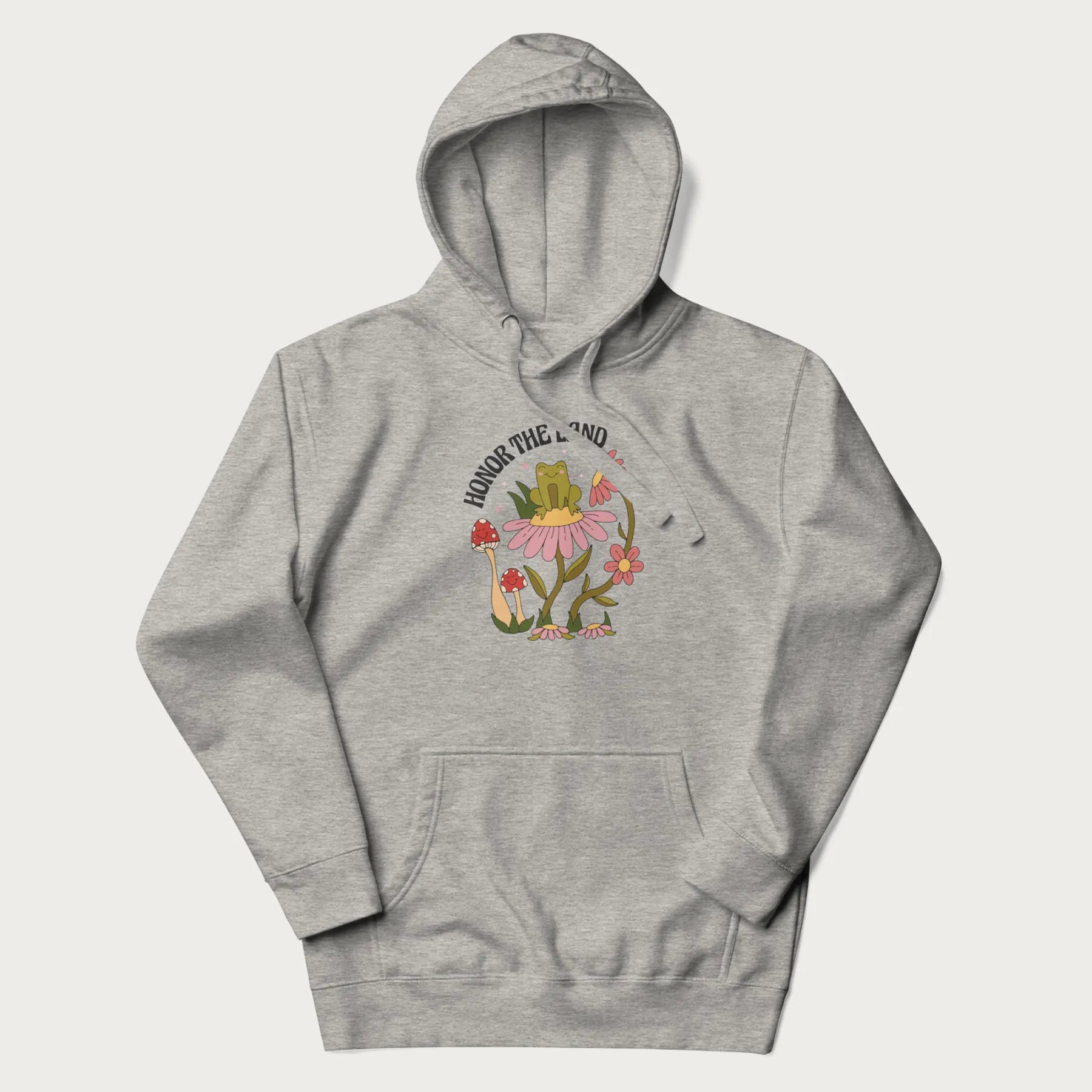 Light grey hoodie with a graphic of a frog sitting on a flower, surrounded by mushrooms and flowers, with the text 'Honor the Land'.