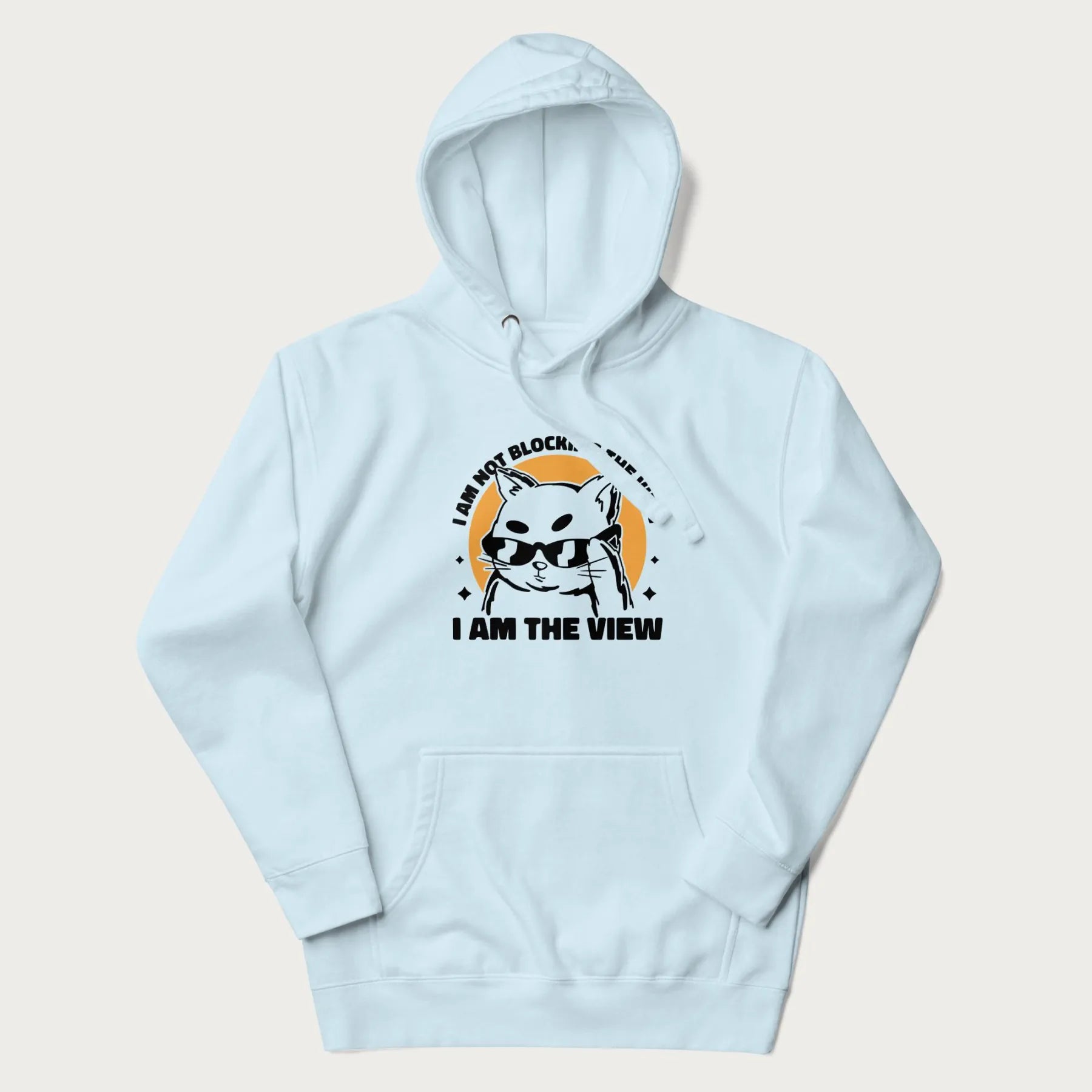Light blue hoodie with a confident cat wearing sunglasses and the phrase 'I am not blocking the view, I am the view'.