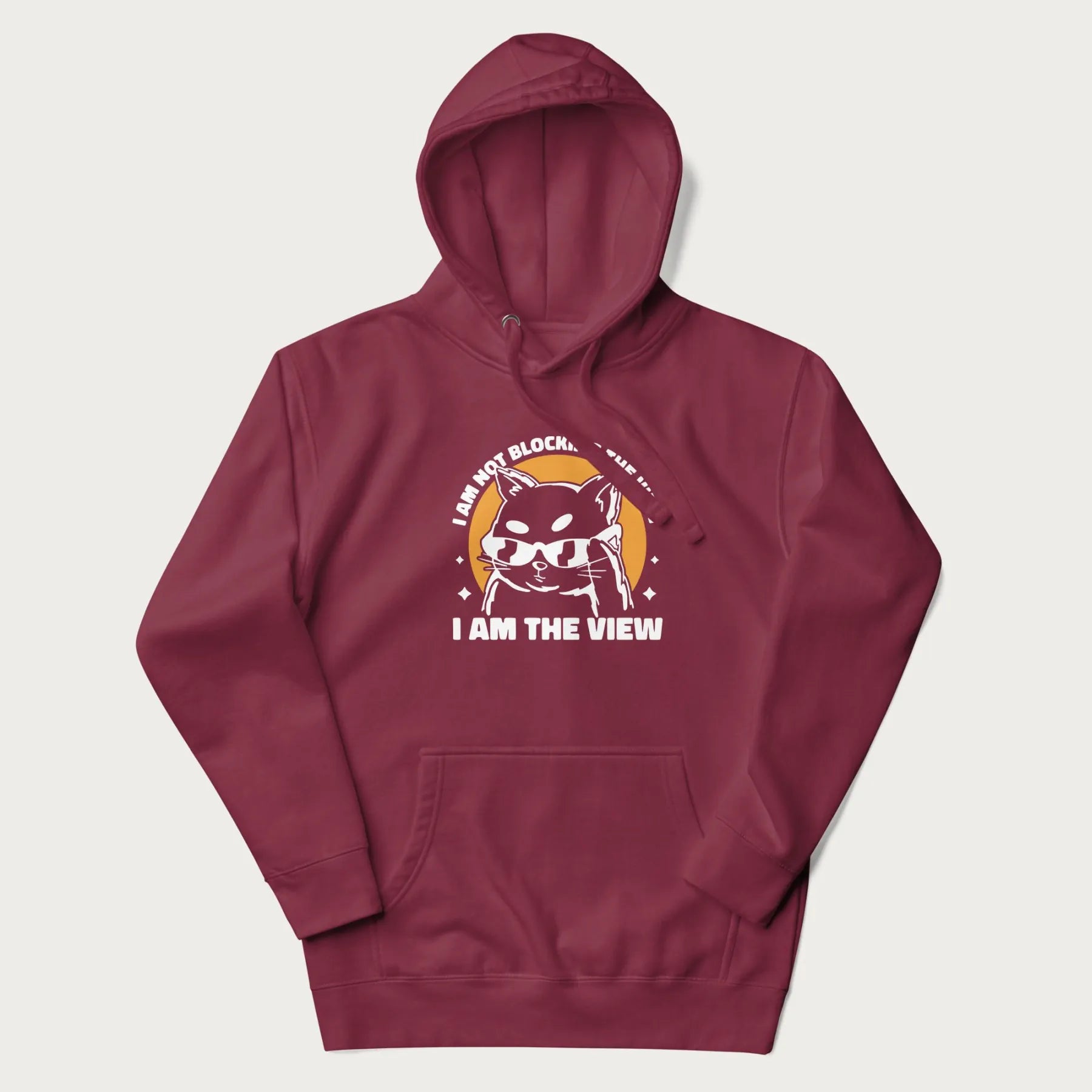 Maroon hoodie with a confident cat wearing sunglasses and the phrase 'I am not blocking the view, I am the view'.
