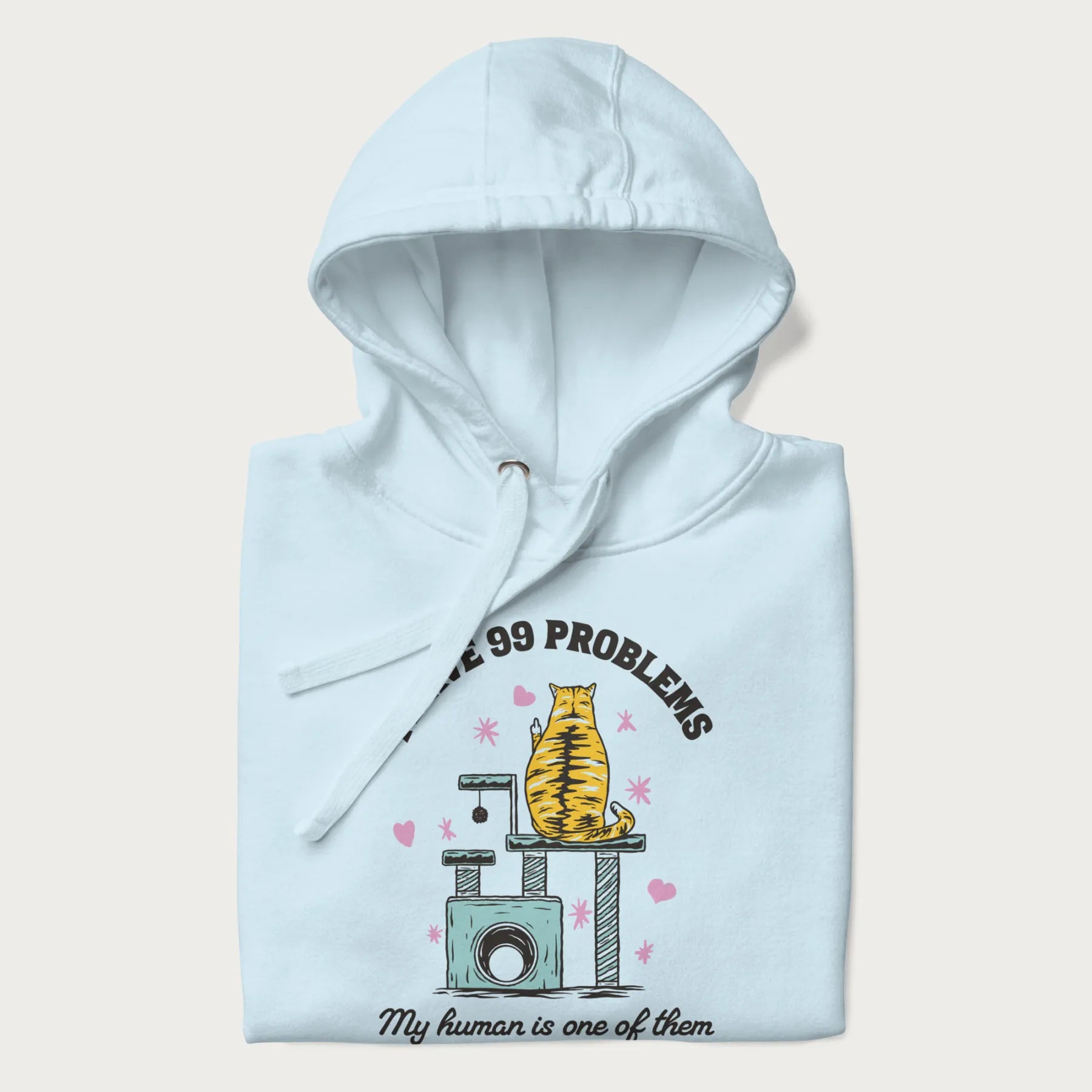 Folded light blue hoodie with graphic of a cat on a scratching post and text 'i have 99 problems, my human is one of them'.