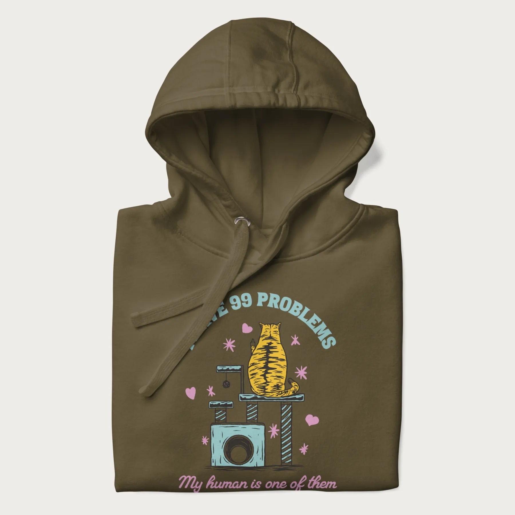 Folded military green hoodie with graphic of a cat on a scratching post and text 'i have 99 problems, my human is one of them'.