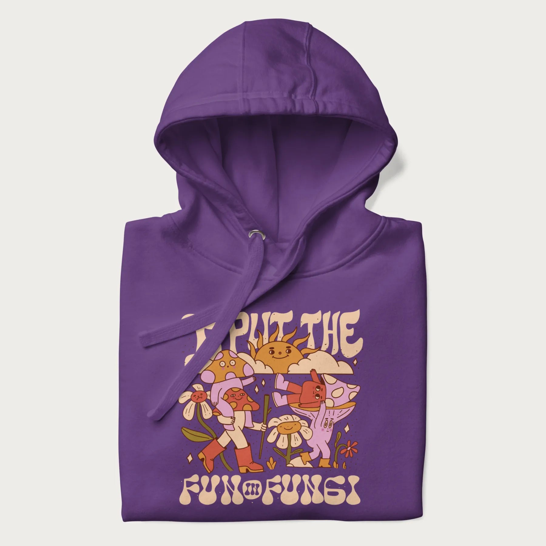 Folded purple hoodie with a graphic of cheerful mushroom characters and the text 'I Put the Fun in Fungi'.