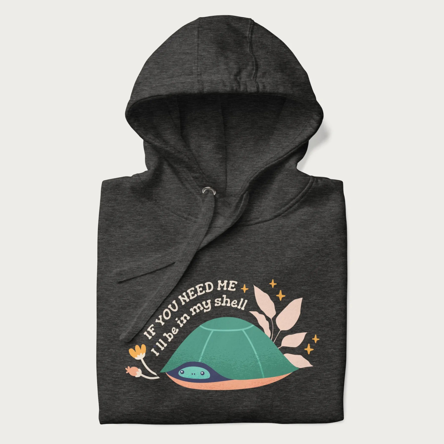 Folded dark grey hoodie with a graphic of a turtle peeking out from its shell and the text 'If You Need Me I'll be in my shell'.
