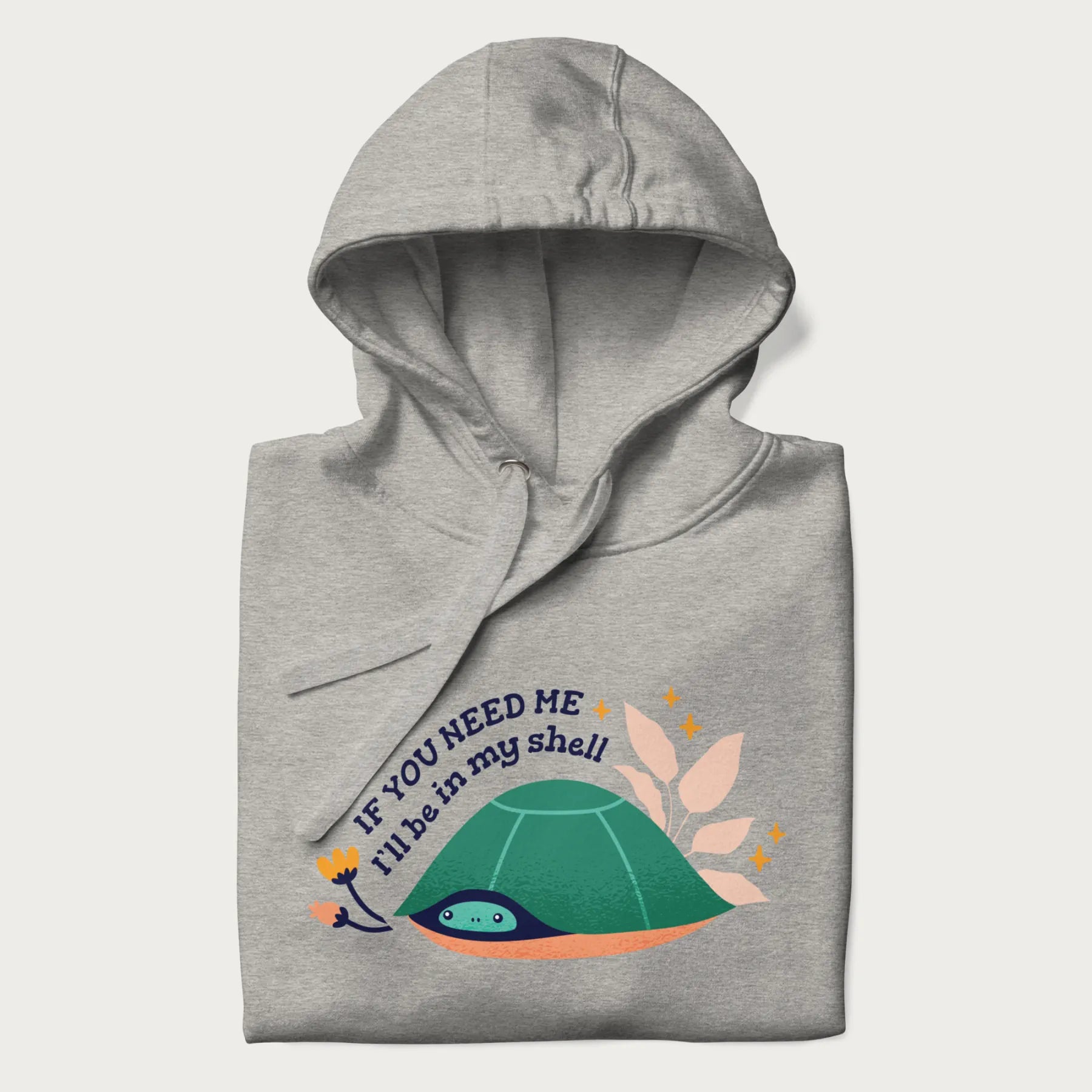 Folded light grey hoodie with a graphic of a turtle peeking out from its shell and the text 'If You Need Me I'll be in my shell'.