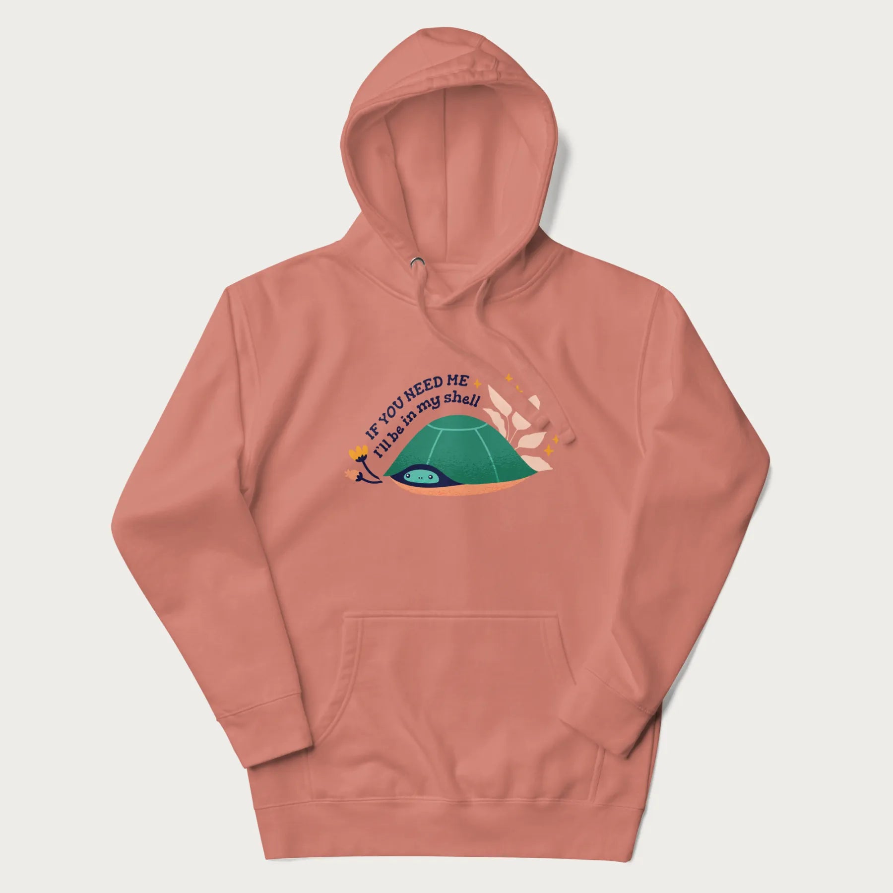 Light pink hoodie with a graphic of a turtle peeking out from its shell and the text 'If You Need Me I'll be in my shell'.