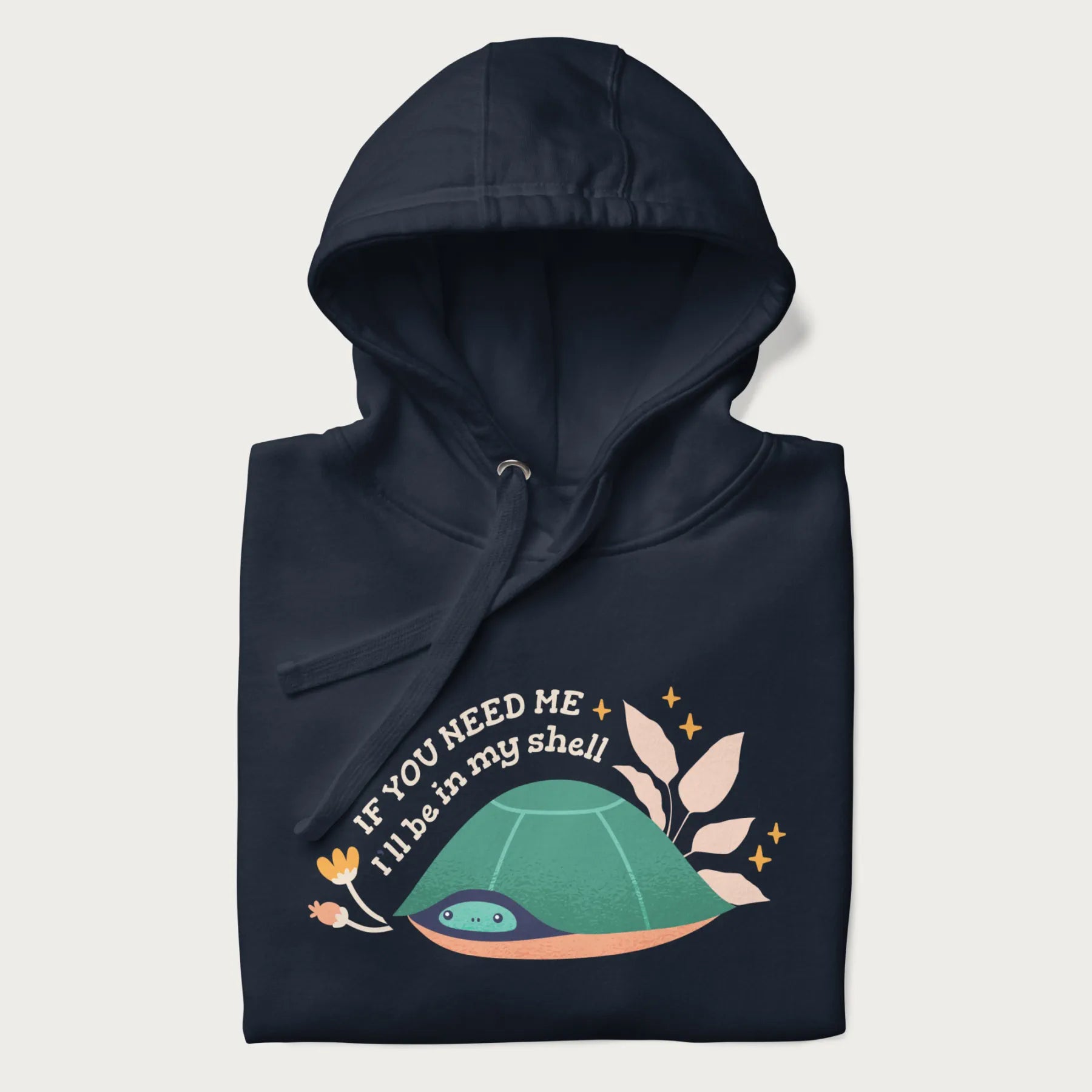 Folded navy blue hoodie with a graphic of a turtle peeking out from its shell and the text 'If You Need Me I'll be in my shell'.