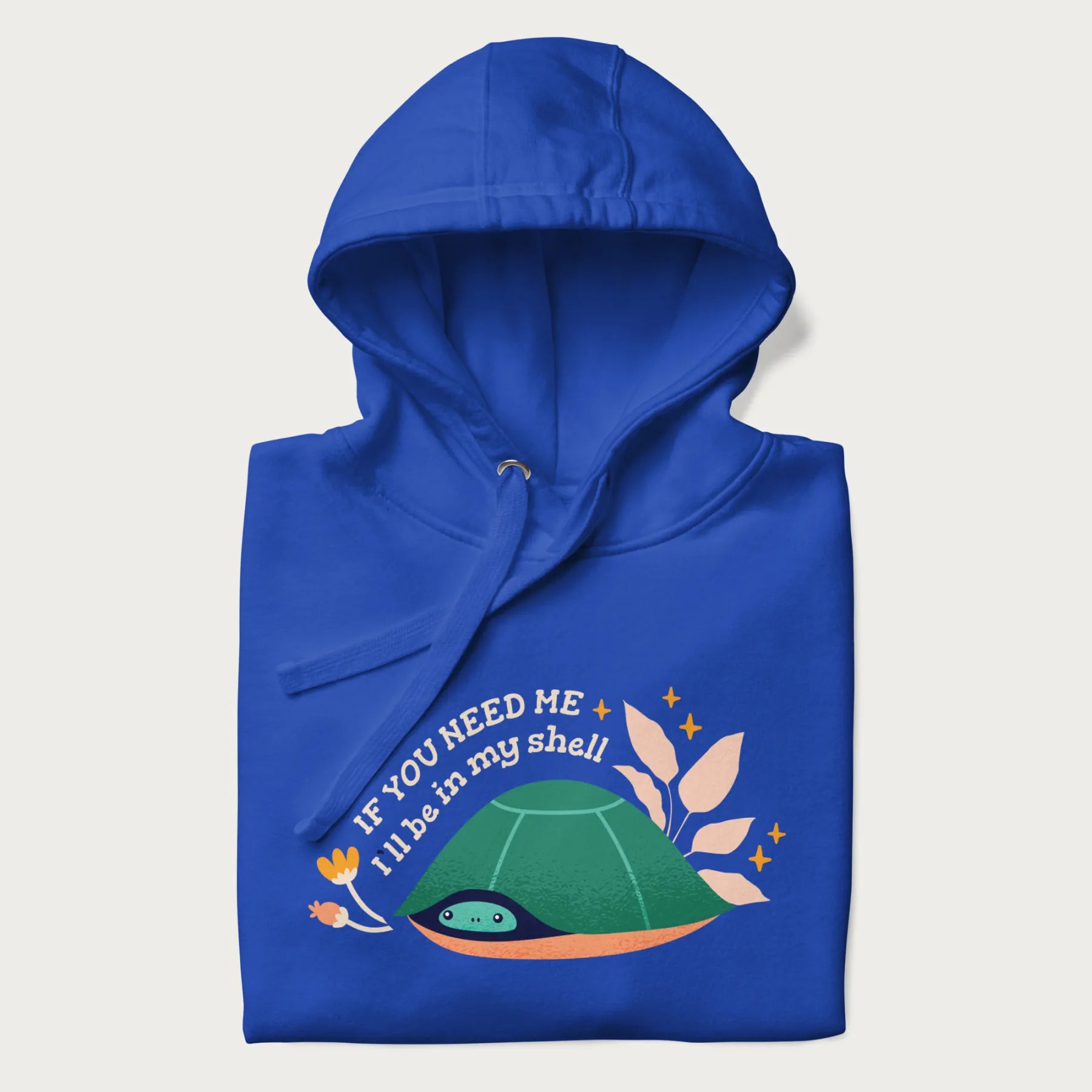 Folded royal blue hoodie with a graphic of a turtle peeking out from its shell and the text 'If You Need Me I'll be in my shell'.