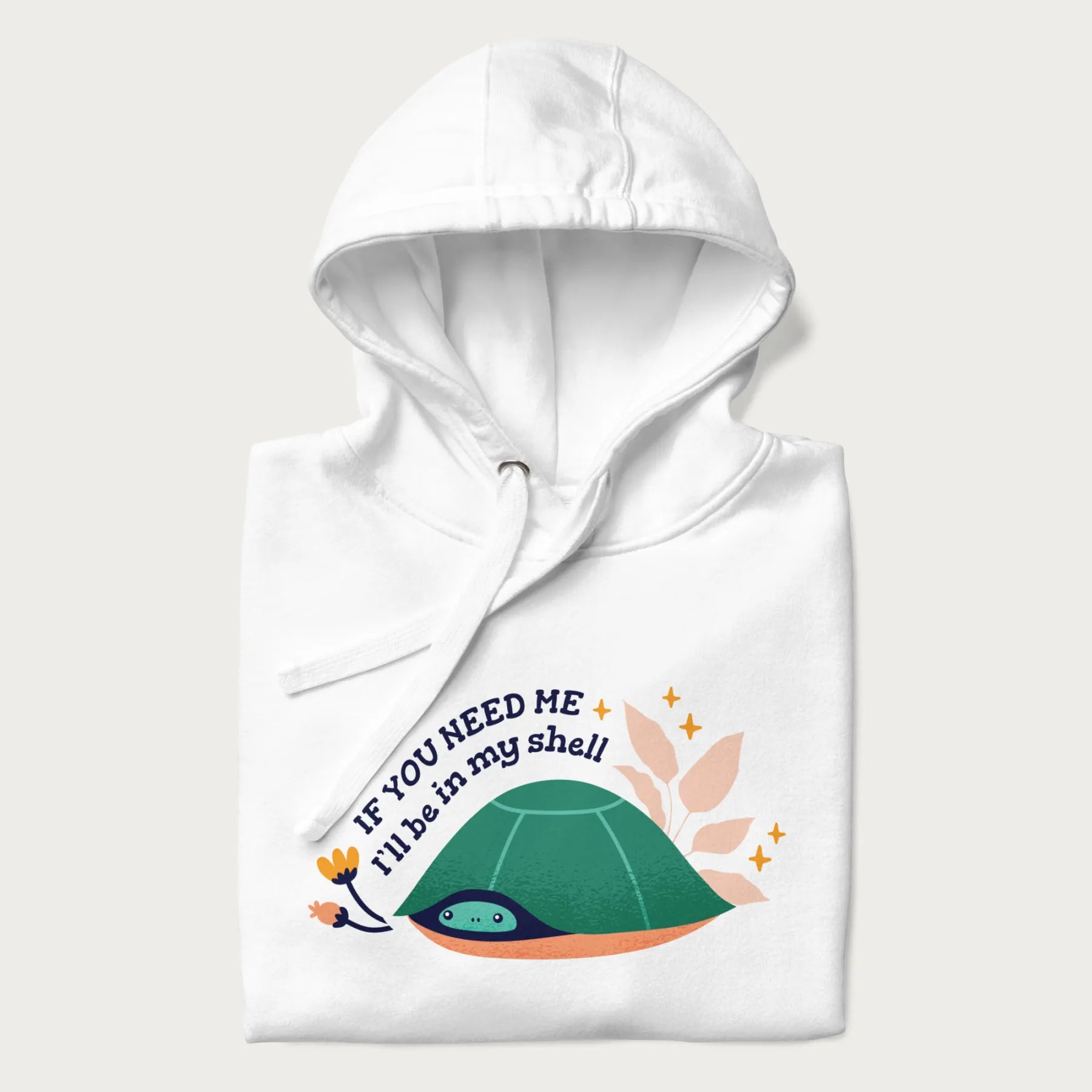 Folded white hoodie with a graphic of a turtle peeking out from its shell and the text 'If You Need Me I'll be in my shell'.