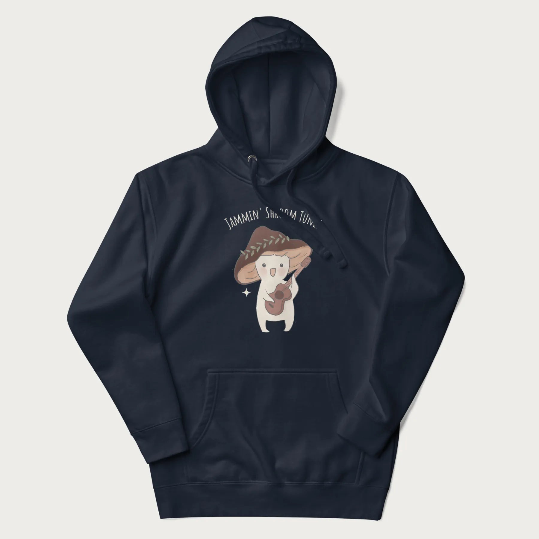 Navy blue hoodie with a cute cottagecore mushroom character playing a guitar and the pun 'Jammin' Shroom Tunes' above.