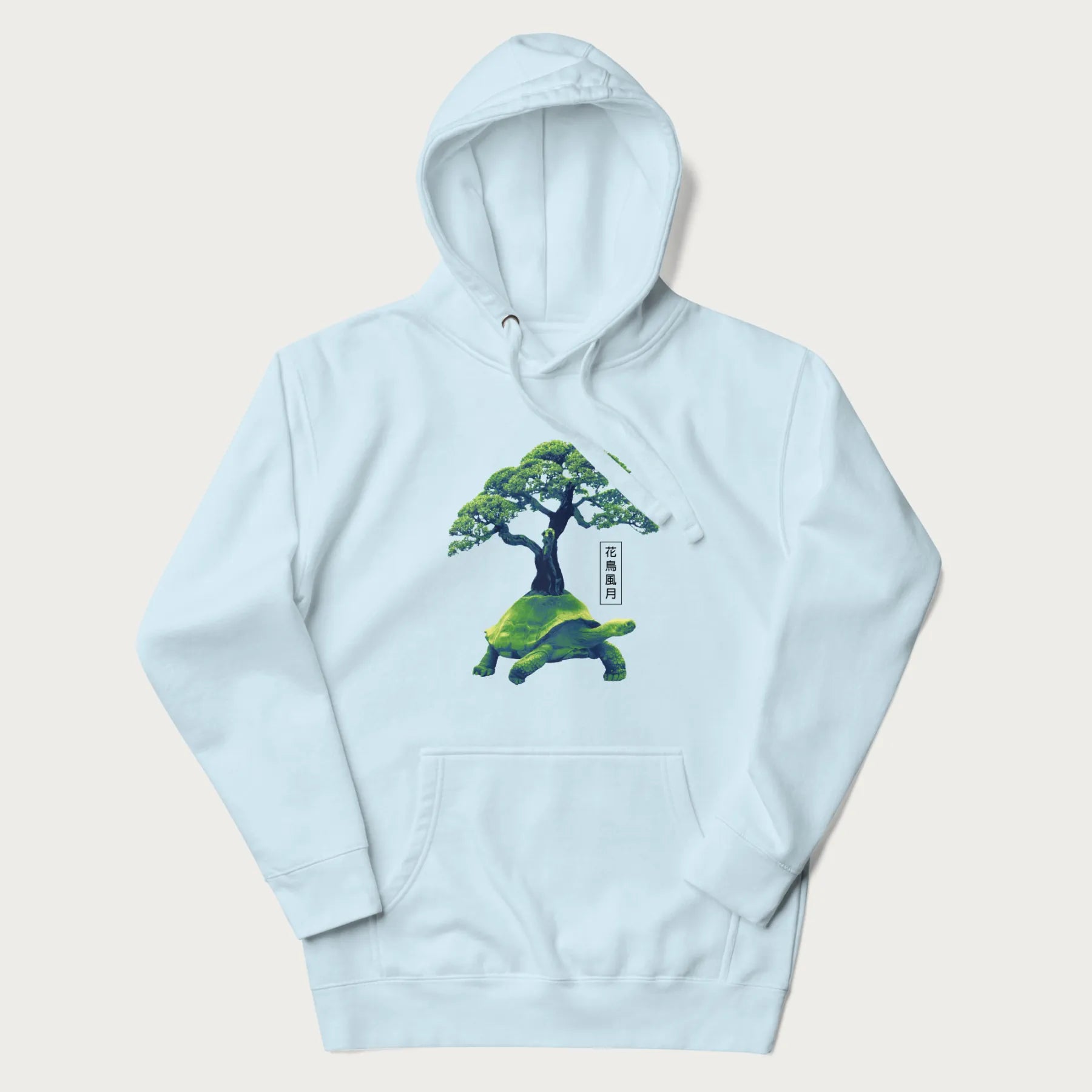 Light blue hoodie with a vibrant graphic of a turtle carrying a bonsai tree and Japanese text '花鳥風月.'