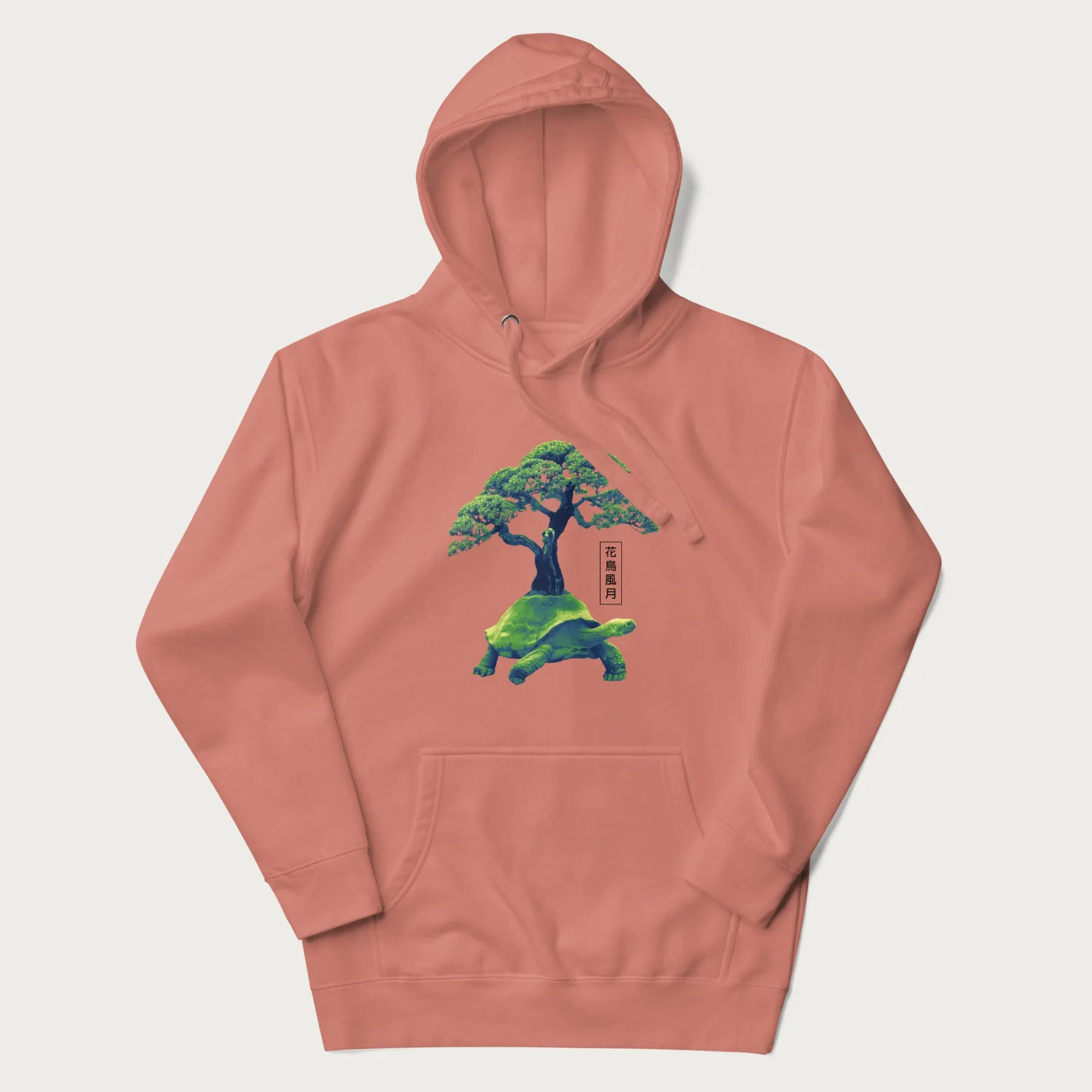 Light pink hoodie with a vibrant graphic of a turtle carrying a bonsai tree and Japanese text '花鳥風月.'