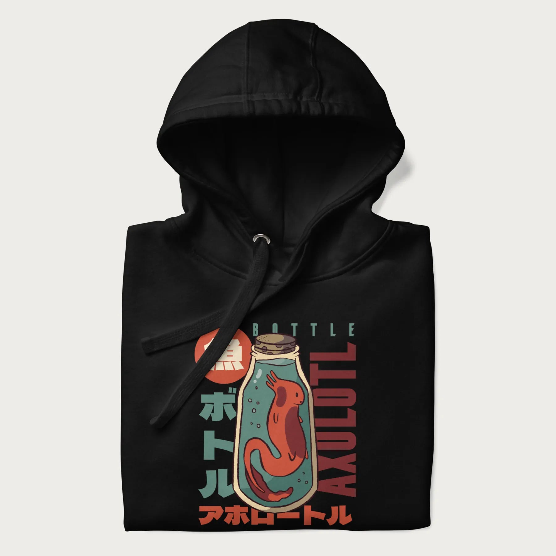 Folded black hoodie with Japanese graphic of a red axolotl in a bottle with Japanese text 'ボトル' (Bottle) and 'アホロートル' (Axolotl).