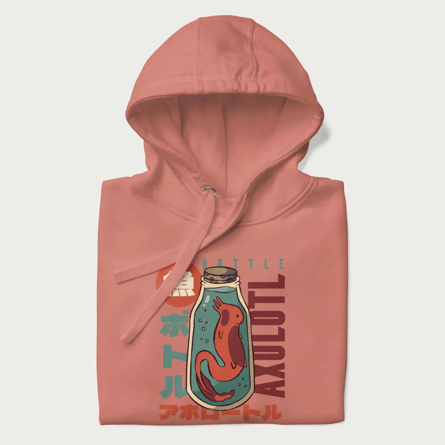 Folded light pink hoodie with Japanese graphic of a red axolotl in a bottle with Japanese text 'ボトル' (Bottle) and 'アホロートル' (Axolotl).