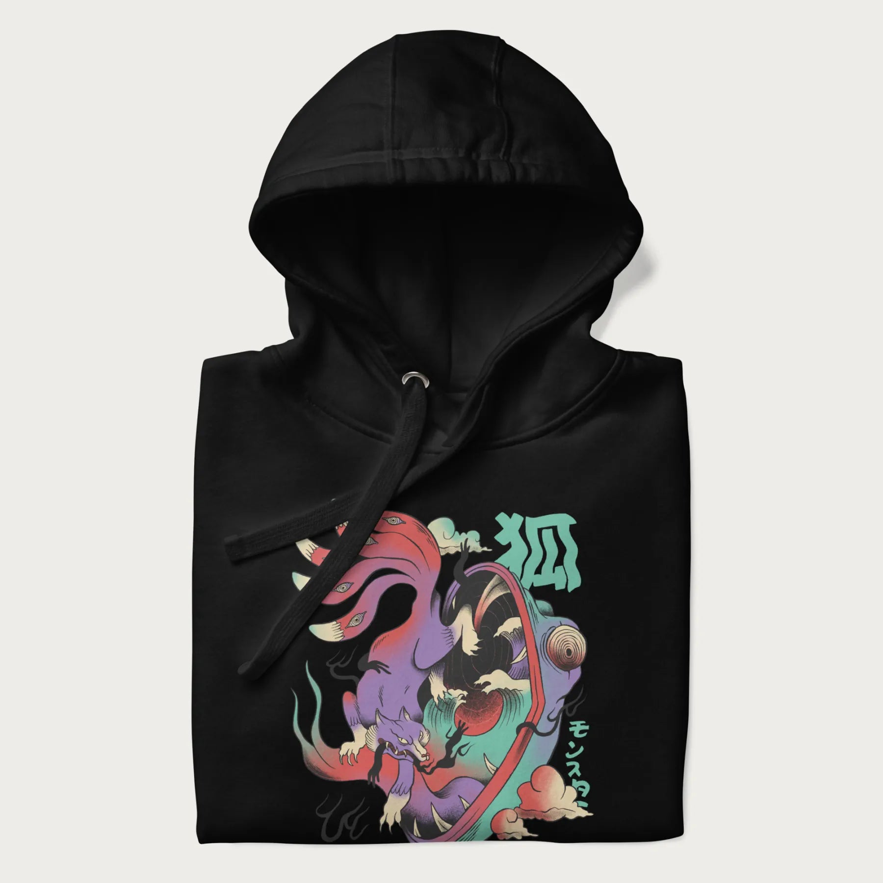 Folded black hoodie with Japanese 9 tailed fox graphic and Japanese text '狐' (Fox) and 'モンスター' (Monster), in vivid psychedelic colors.