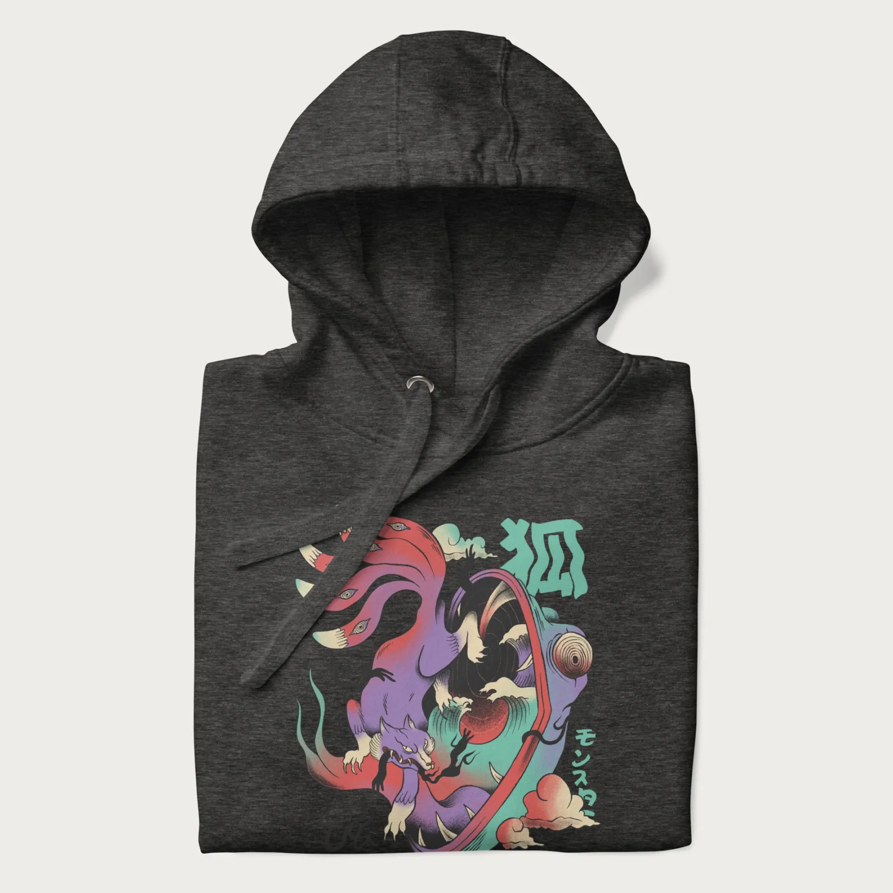 Folded dark grey hoodie with Japanese 9 tailed fox graphic and Japanese text '狐' (Fox) and 'モンスター' (Monster), in vivid psychedelic colors.