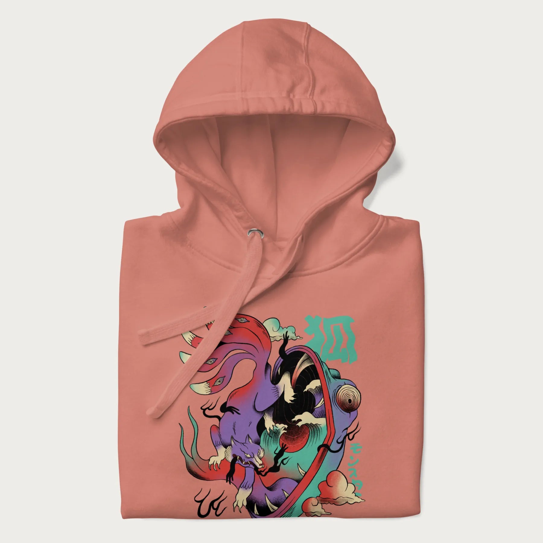 Folded light pink hoodie with Japanese 9 tailed fox graphic and Japanese text '狐' (Fox) and 'モンスター' (Monster), in vivid psychedelic colors.