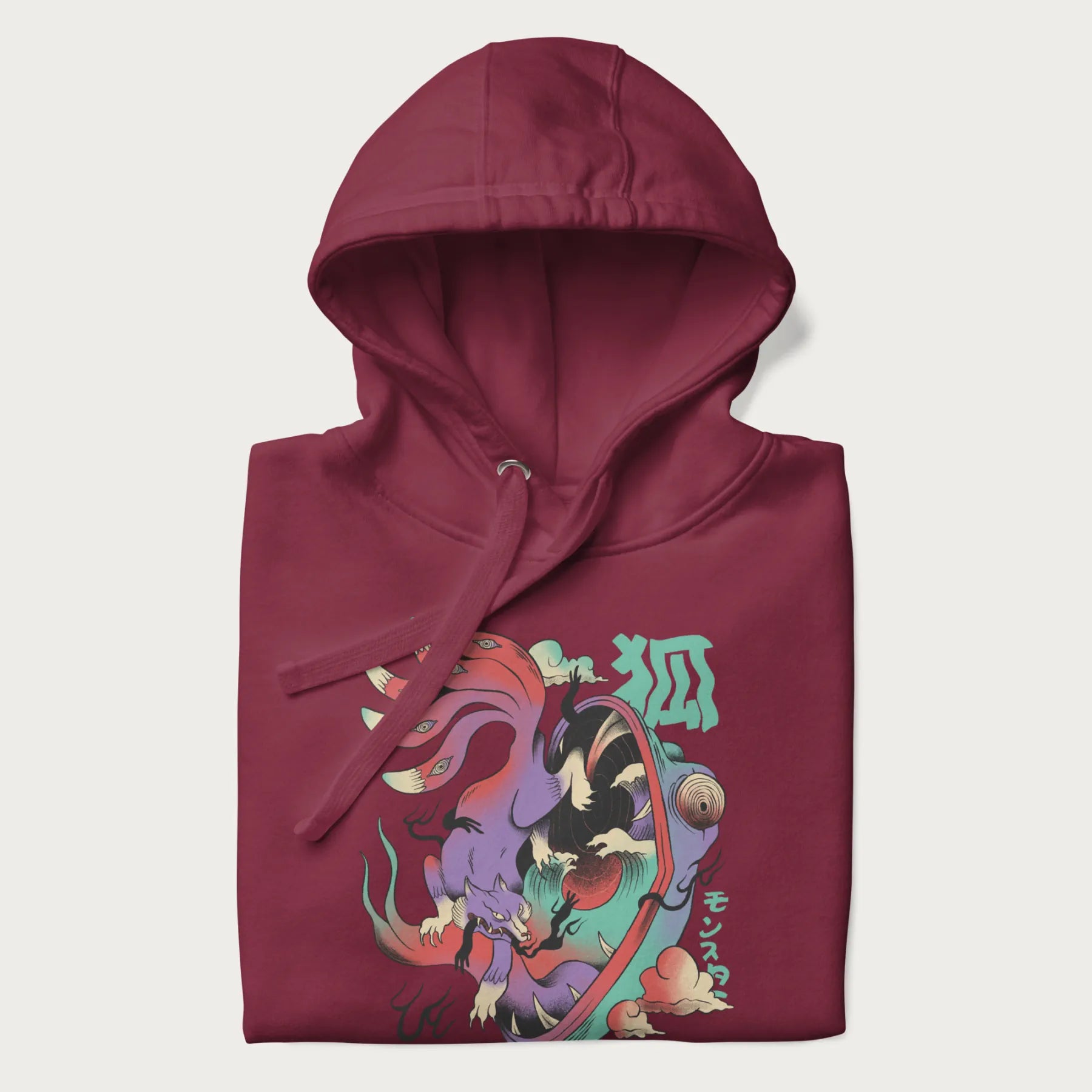 Folded maroon hoodie with Japanese 9 tailed fox graphic and Japanese text '狐' (Fox) and 'モンスター' (Monster), in vivid psychedelic colors.
