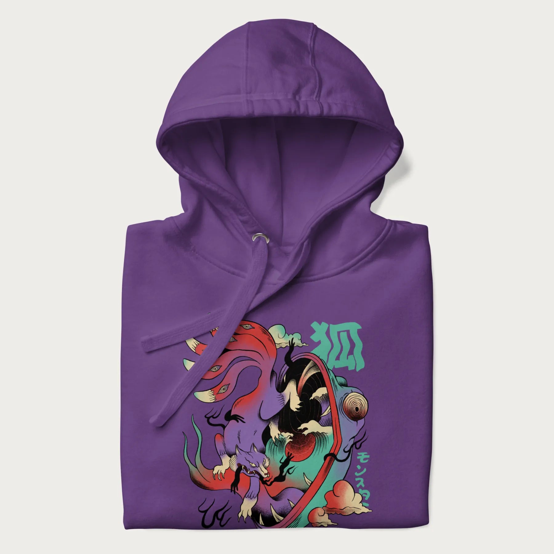 Folded purple hoodie with Japanese 9 tailed fox graphic and Japanese text '狐' (Fox) and 'モンスター' (Monster), in vivid psychedelic colors.