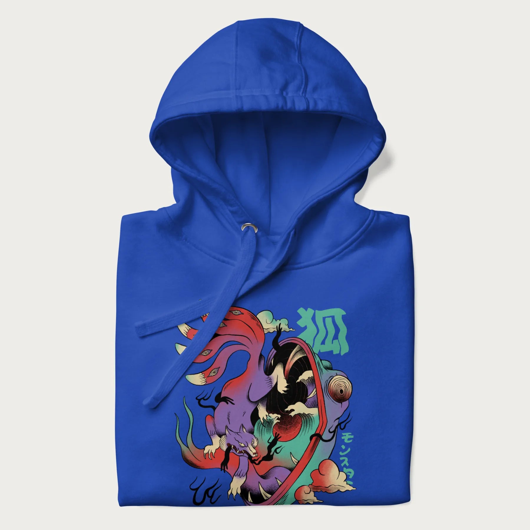 Folded royal blue hoodie with Japanese 9 tailed fox graphic and Japanese text '狐' (Fox) and 'モンスター' (Monster), in vivid psychedelic colors.