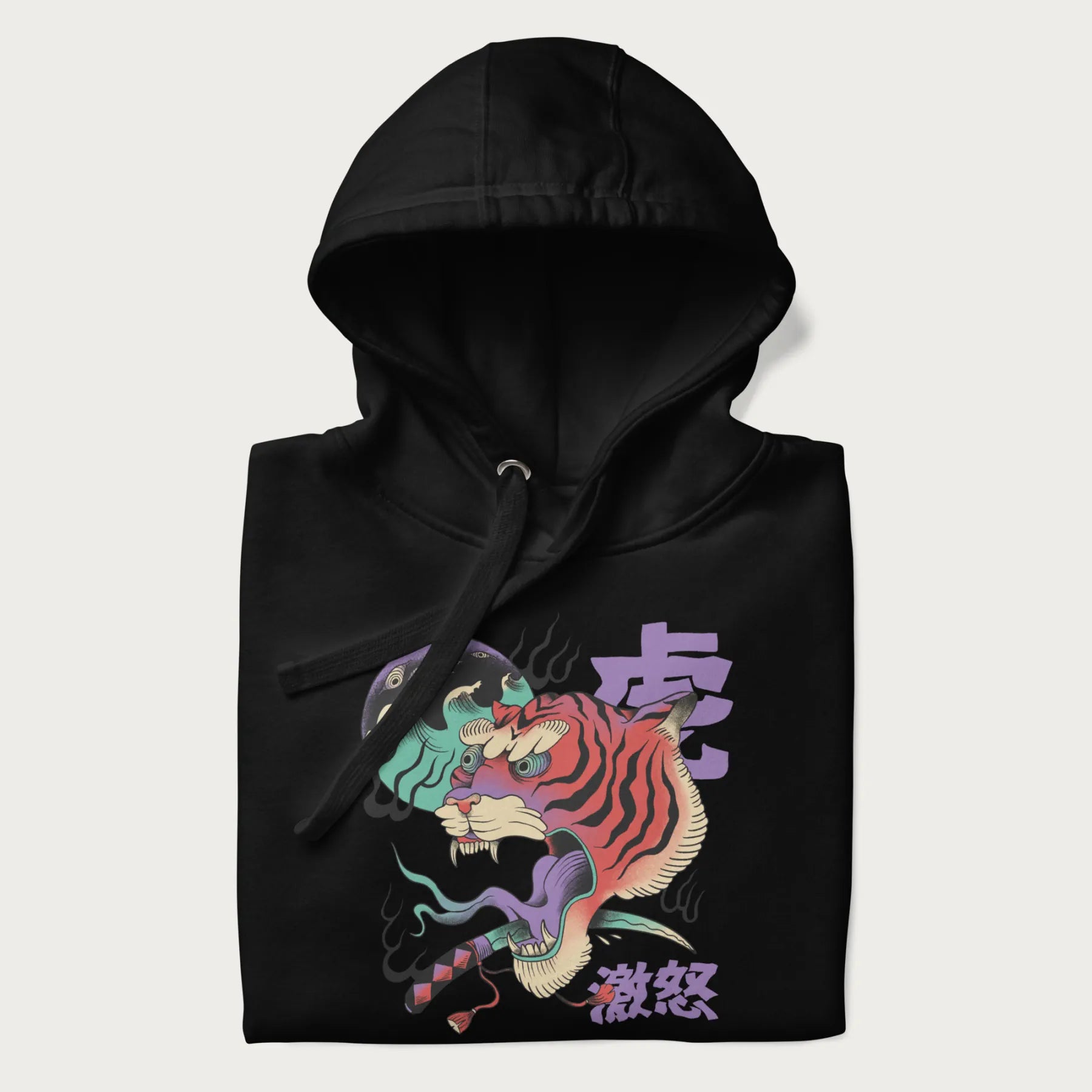 Folded black hoodie with Japanese tiger graphic, rendered in vivid orange and purple, with Japanese text '虎' (Tiger) and '激怒' (Rage).
