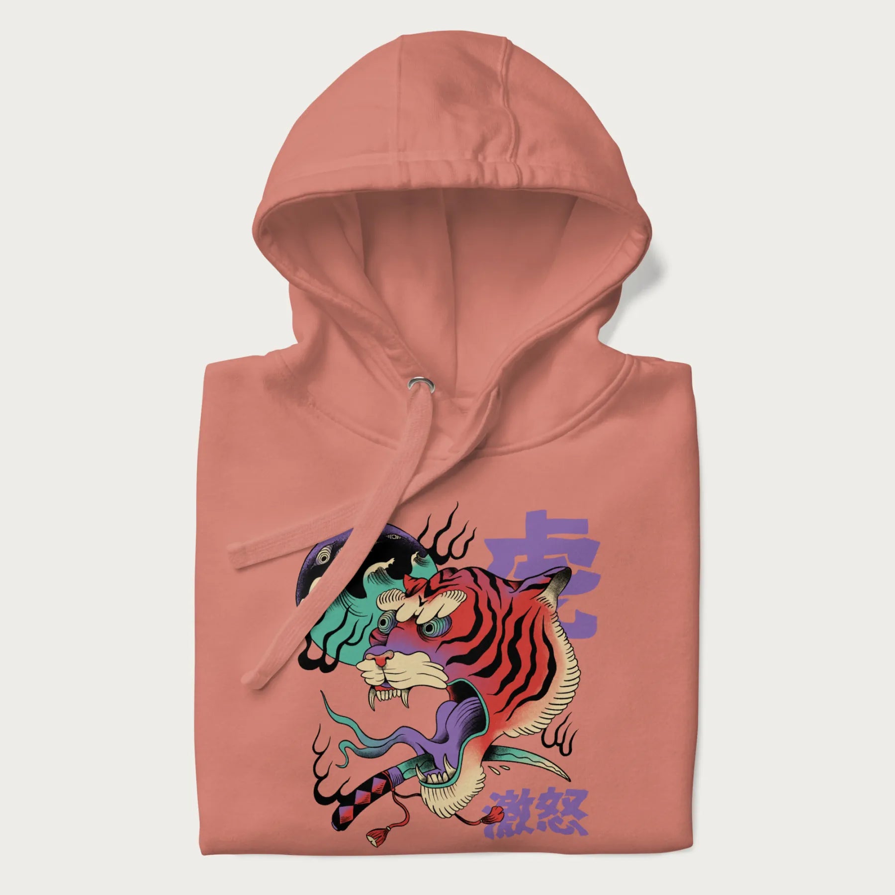 Folded light pink hoodie with Japanese tiger graphic, rendered in vivid orange and purple, with Japanese text '虎' (Tiger) and '激怒' (Rage).
