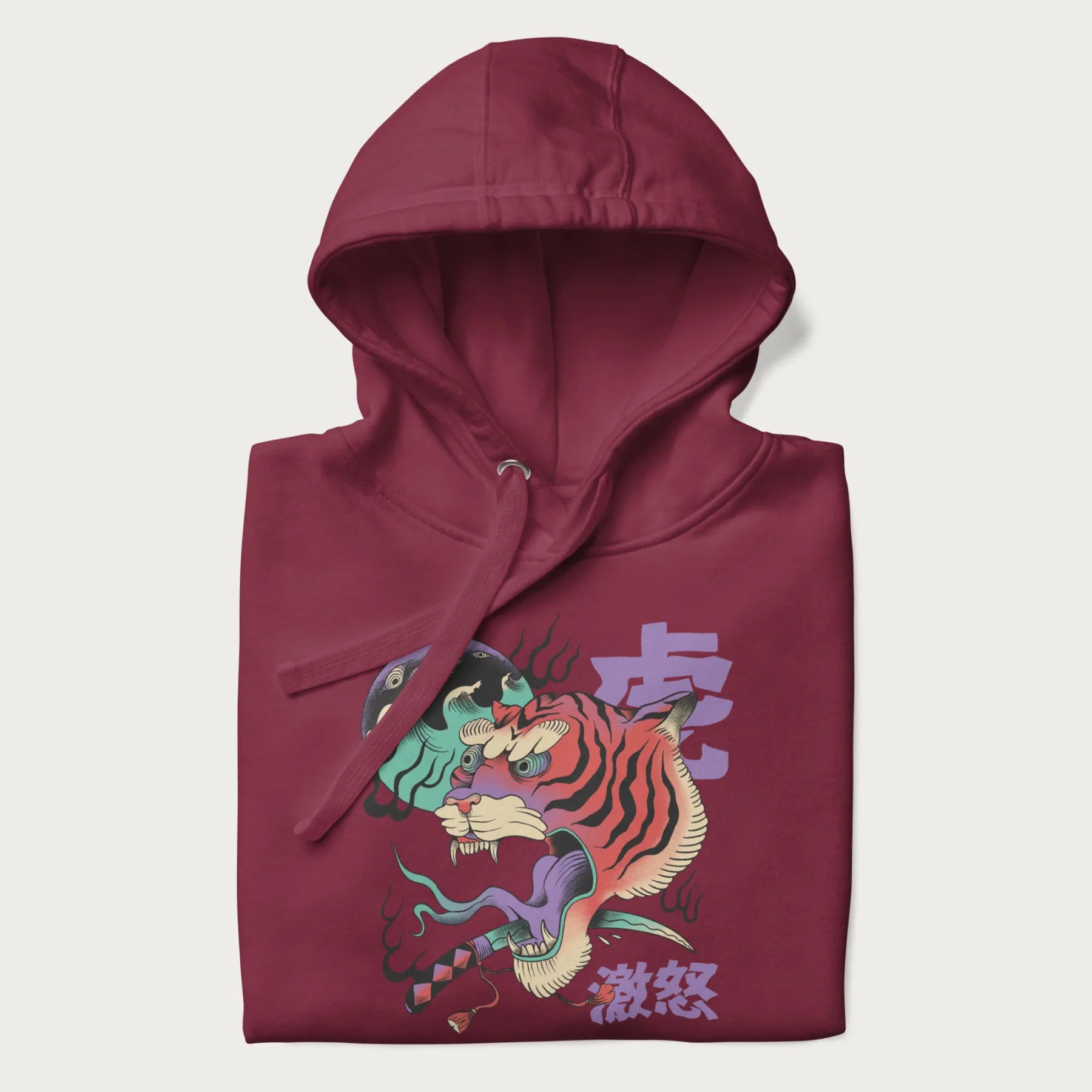 Folded maroon hoodie with Japanese tiger graphic, rendered in vivid orange and purple, with Japanese text '虎' (Tiger) and '激怒' (Rage).