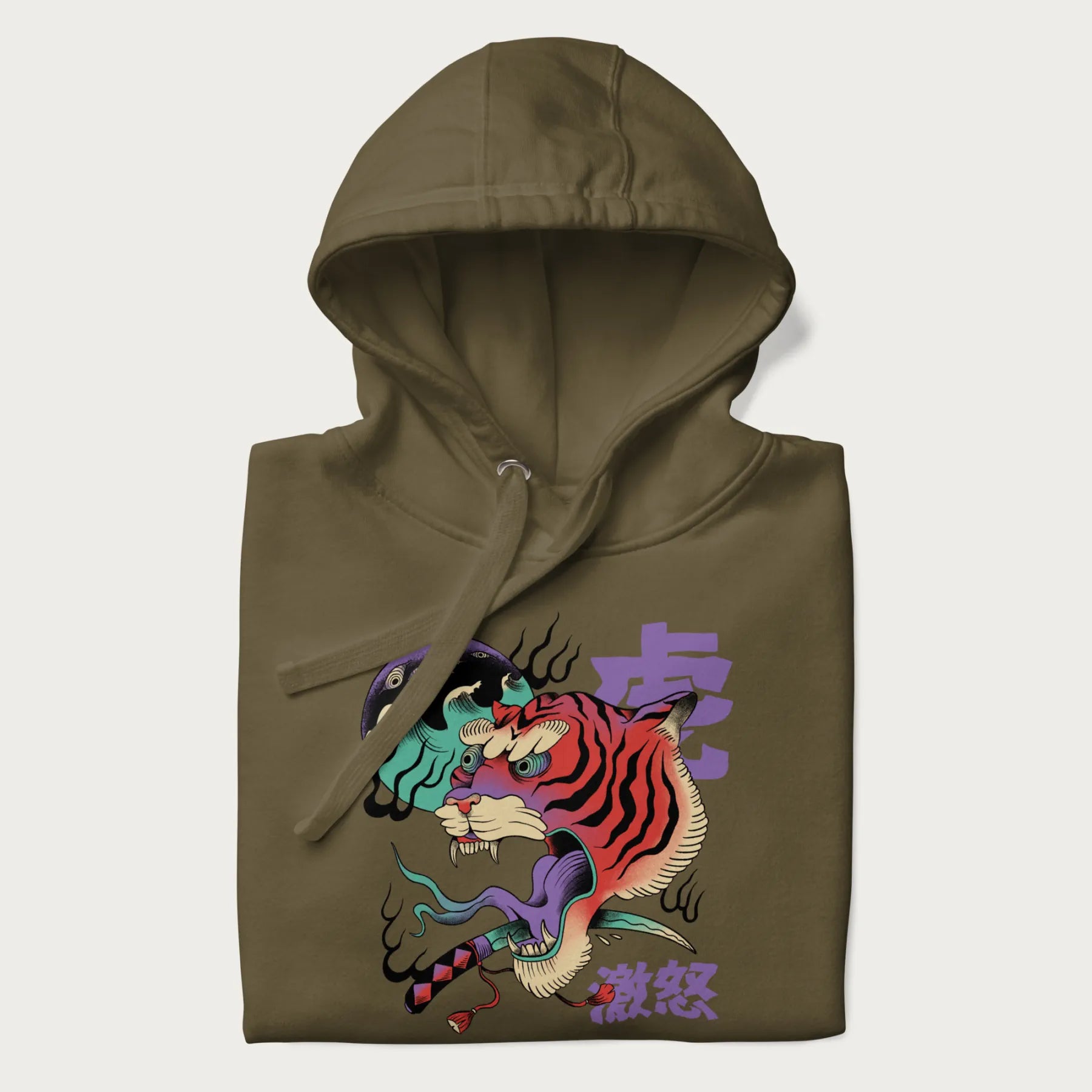 Folded military green hoodie with Japanese tiger graphic, rendered in vivid orange and purple, with Japanese text '虎' (Tiger) and '激怒' (Rage).