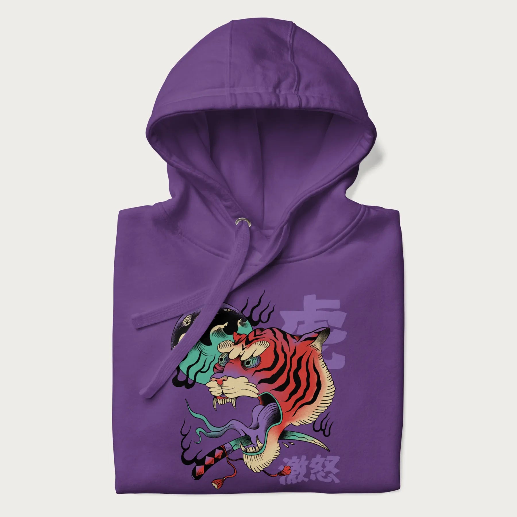 Folded purple hoodie with Japanese tiger graphic, rendered in vivid orange and purple, with Japanese text '虎' (Tiger) and '激怒' (Rage).