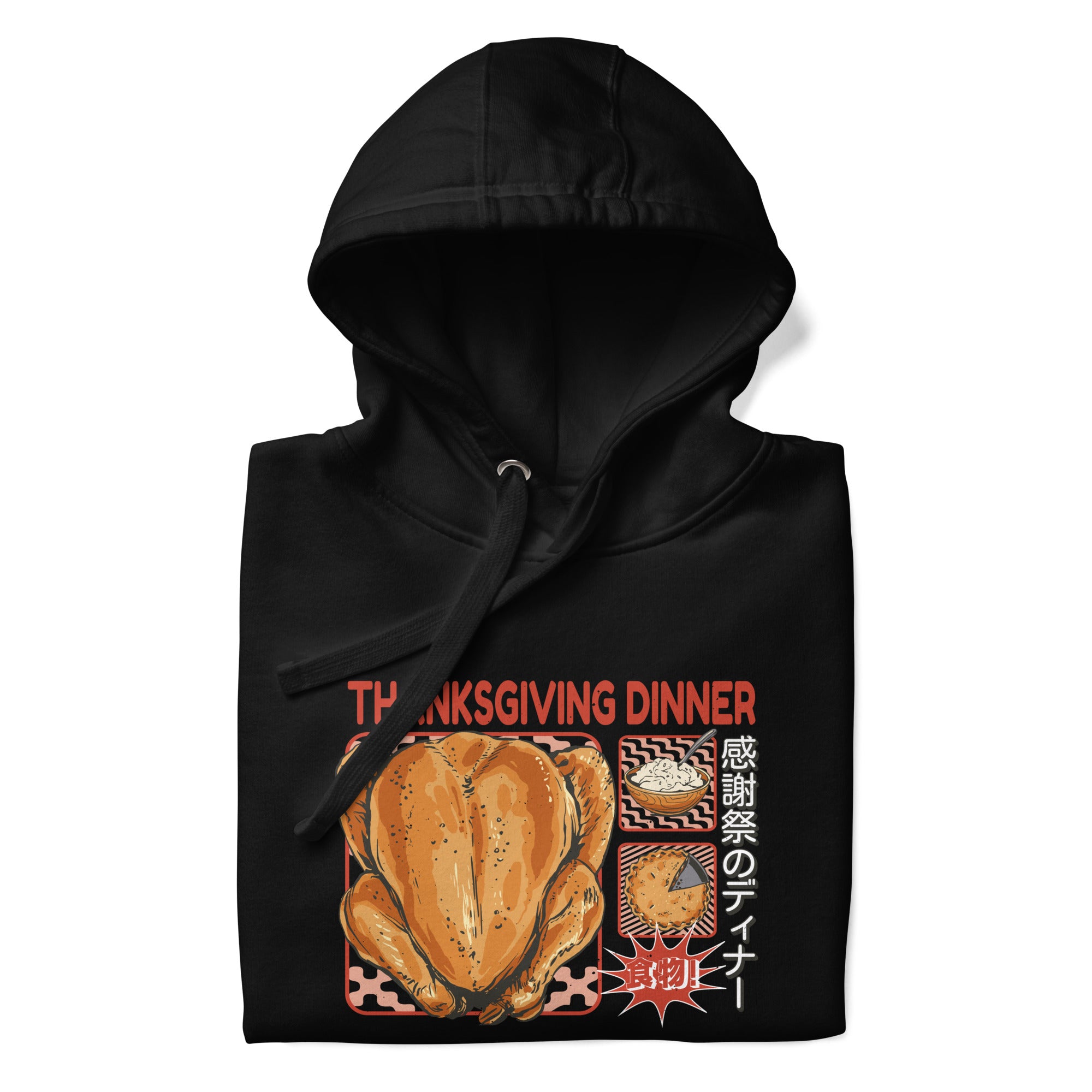 Folded Japanese Thanksgiving Hoodie in Black color: A classic black hoodie featuring a graphic print of a Japanese Thanksgiving, including a roast chicken, Japanese potato salad, and an apple pie. The hoodie is neatly folded.