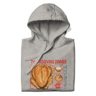 Folded Japanese Thanksgiving Hoodie in Carbon Grey color: A medium gray hoodie with a graphic print showcasing a Japanese Thanksgiving meal, including a roast chicken, Japanese potato salad, and an apple pie. The hoodie is neatly folded.
