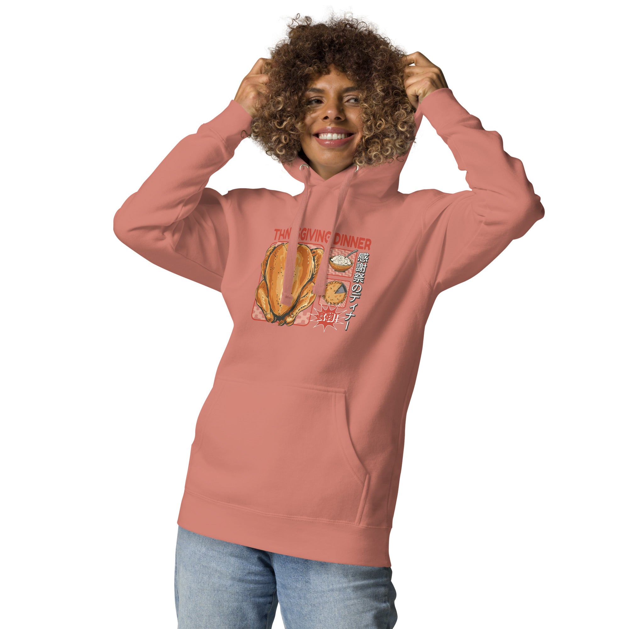 Woman wearing a Japanese Thanksgiving hoodie in Dusty Rose colorway featuring a graphic print of roast chicken, Japanese potato salad, and an apple pie.