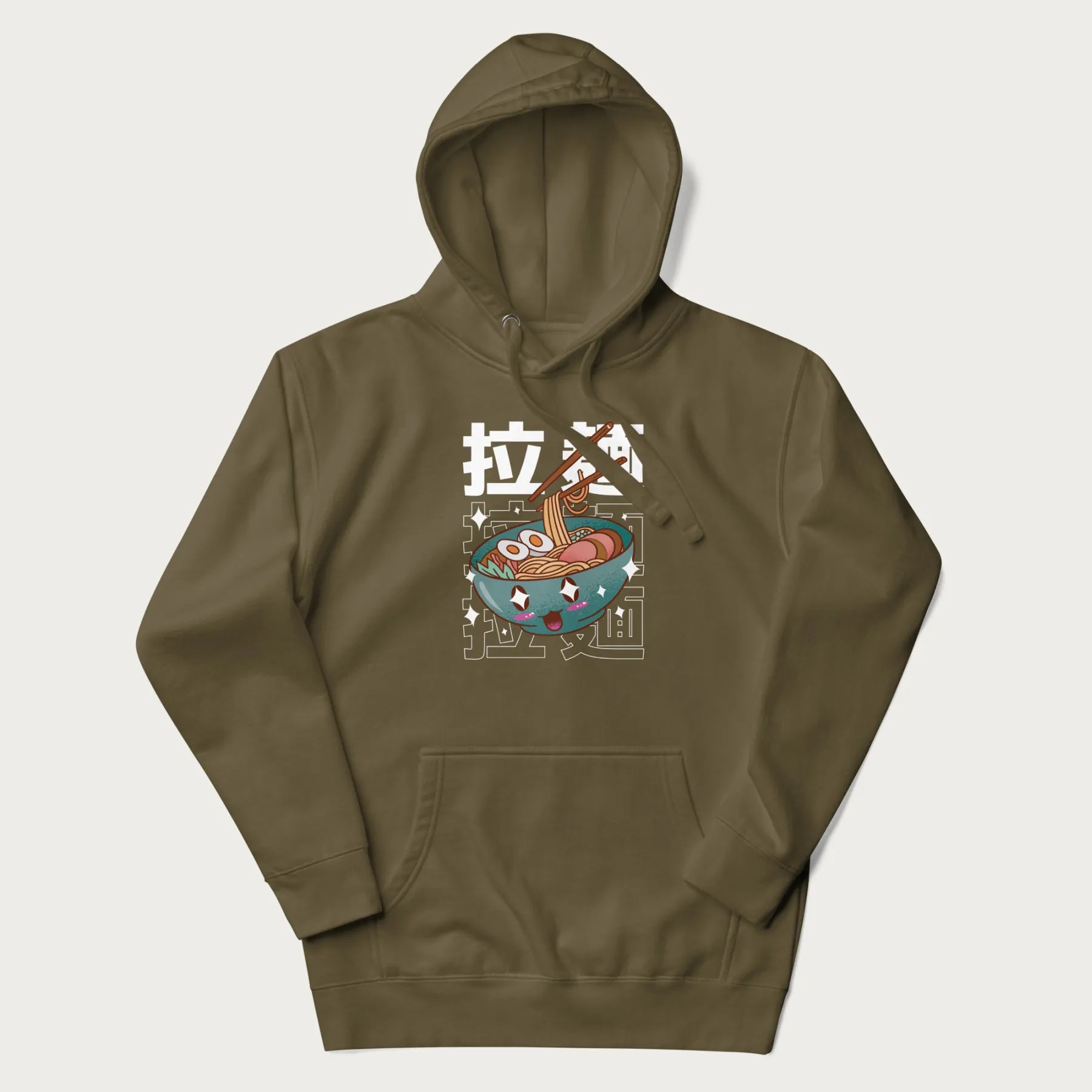Military green hoodie with Japanese text '拉麵' (Ramen) and graphic of a kawaii ramen bowl with sparkling eyes and blushed cheeks.