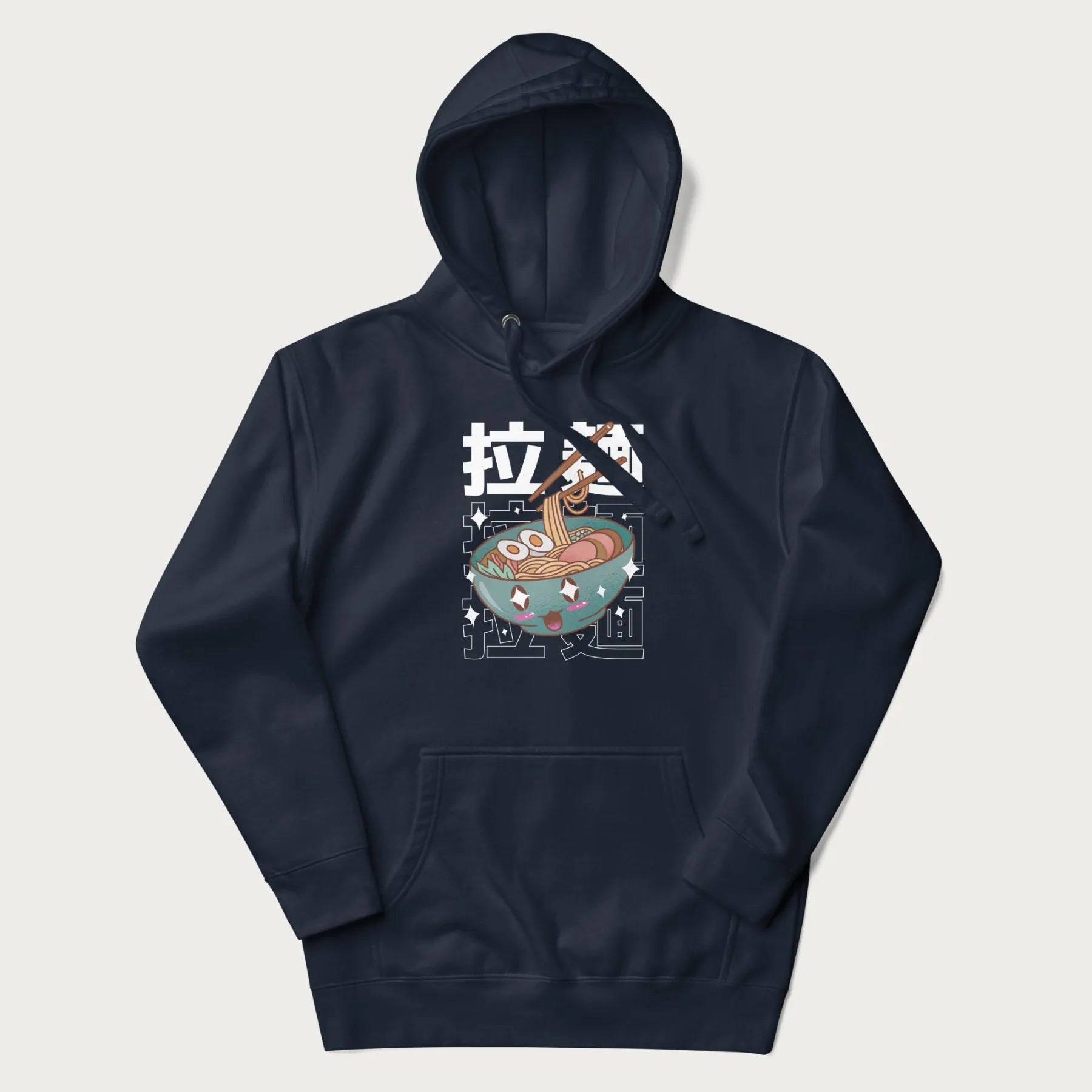 Navy blue hoodie with Japanese text '拉麵' (Ramen) and graphic of a kawaii ramen bowl with sparkling eyes and blushed cheeks.