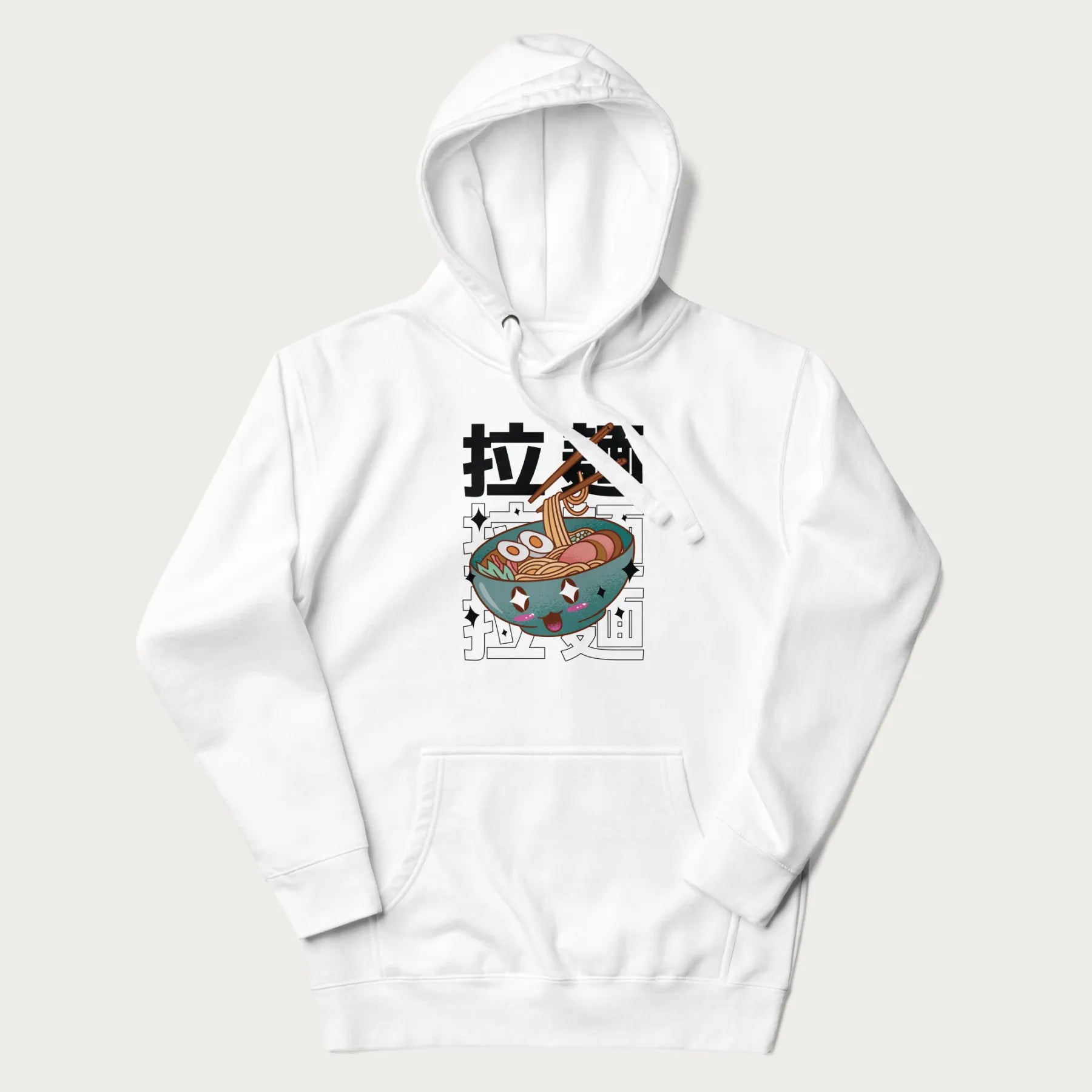 White hoodie with Japanese text '拉麵' (Ramen) and graphic of a kawaii ramen bowl with sparkling eyes and blushed cheeks.