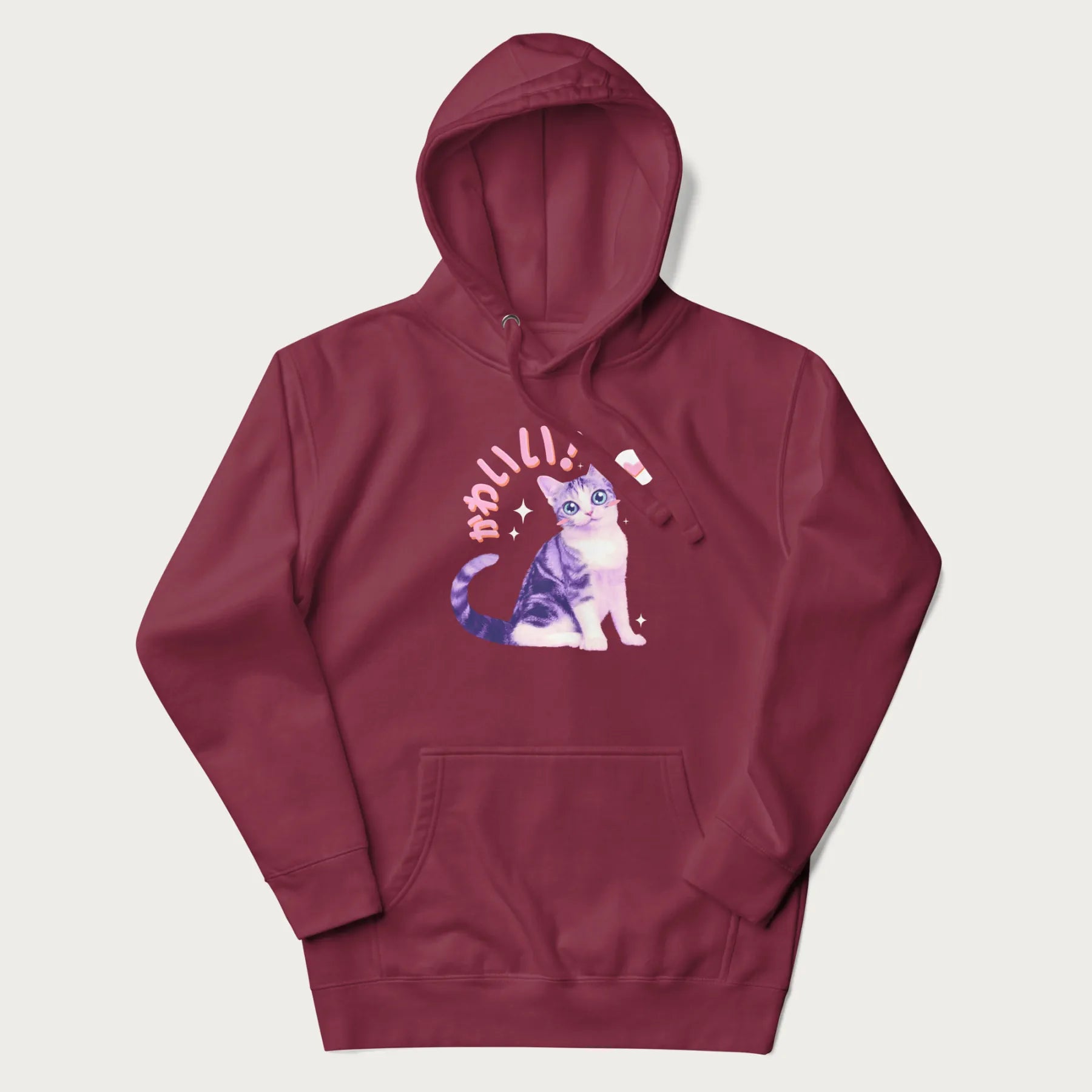 Maroon hoodie with a graphic of a blue-eyed kitten and Japanese kawaii-style lettering, stars, and a heart.
