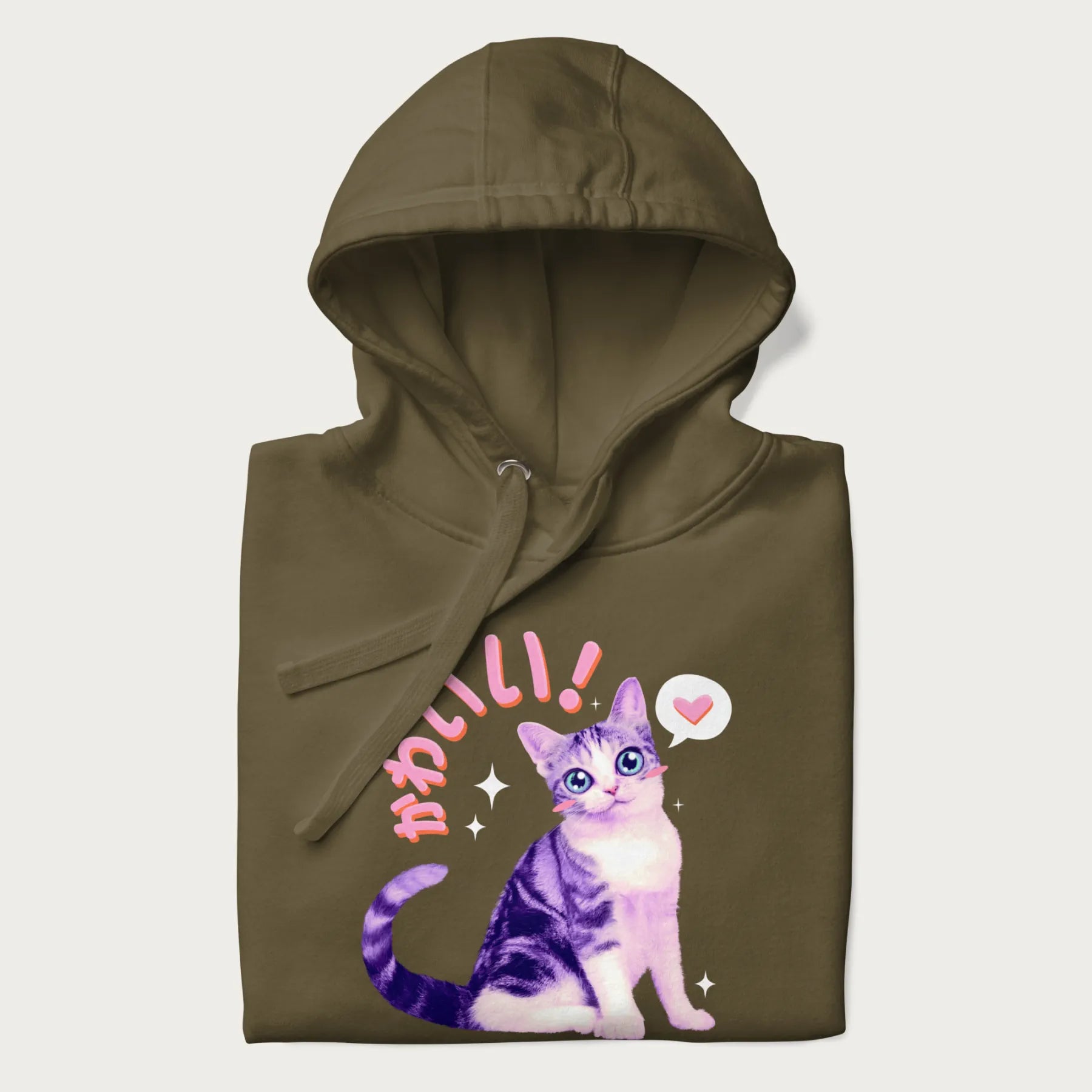 Folded military green hoodie with a graphic of a blue-eyed kitten and Japanese kawaii-style lettering, stars, and a heart.