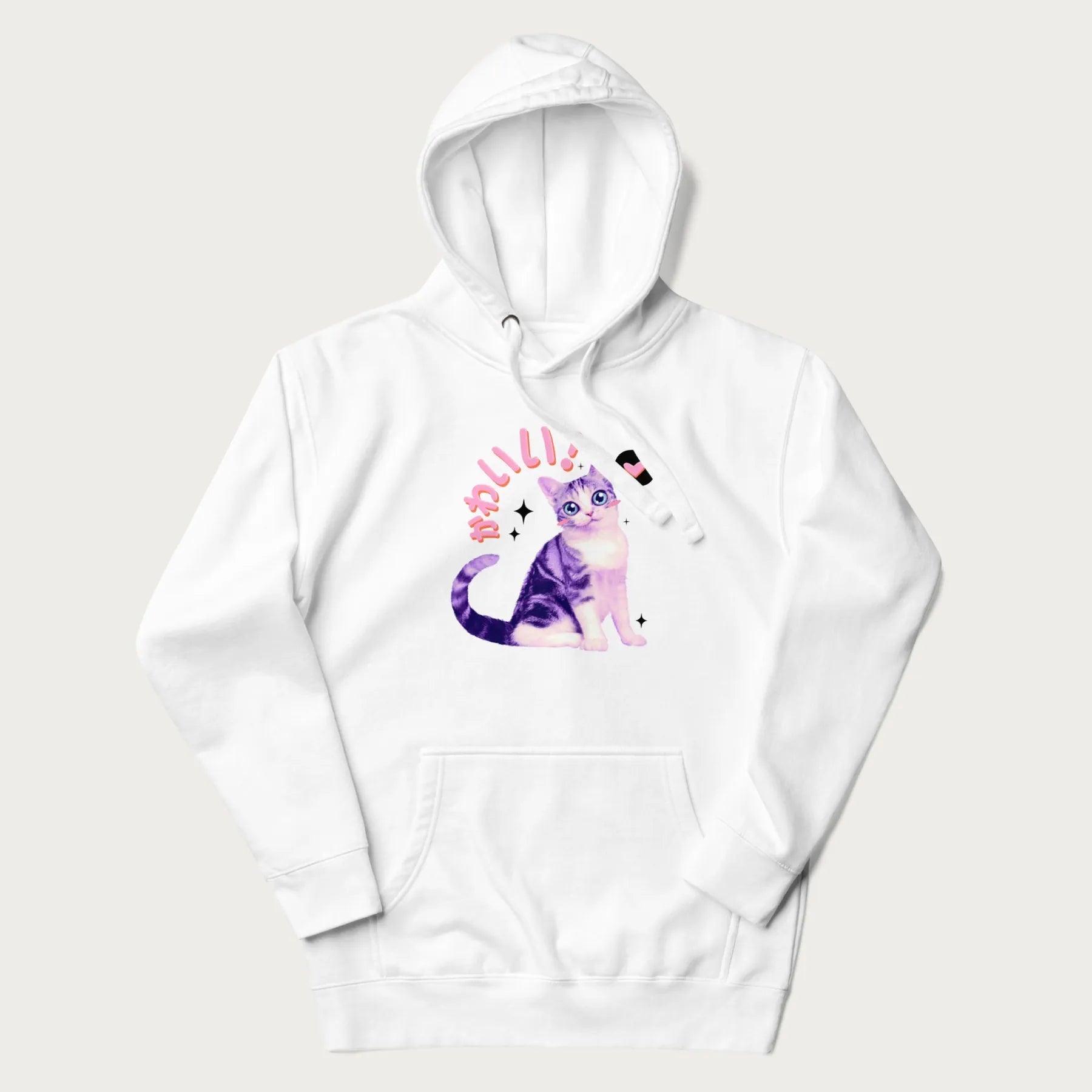 White hoodie with a graphic of a blue-eyed kitten and Japanese kawaii-style lettering, stars, and a heart.