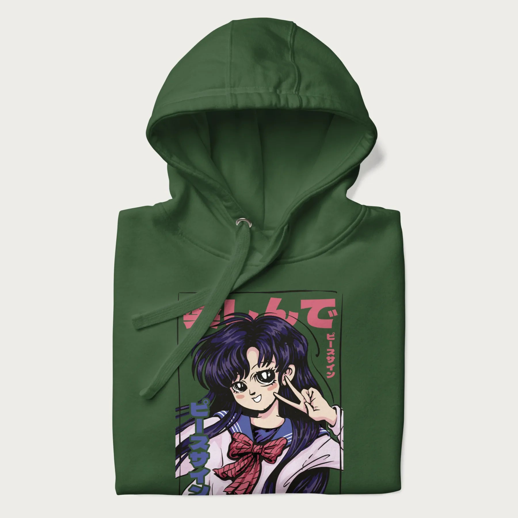 Folded forest green hoodie with Japanese graphic of an anime girl making a peace sign, with Japanese text '楽しんで' (Enjoy) and 'ピースサイン' (Peace Sign).