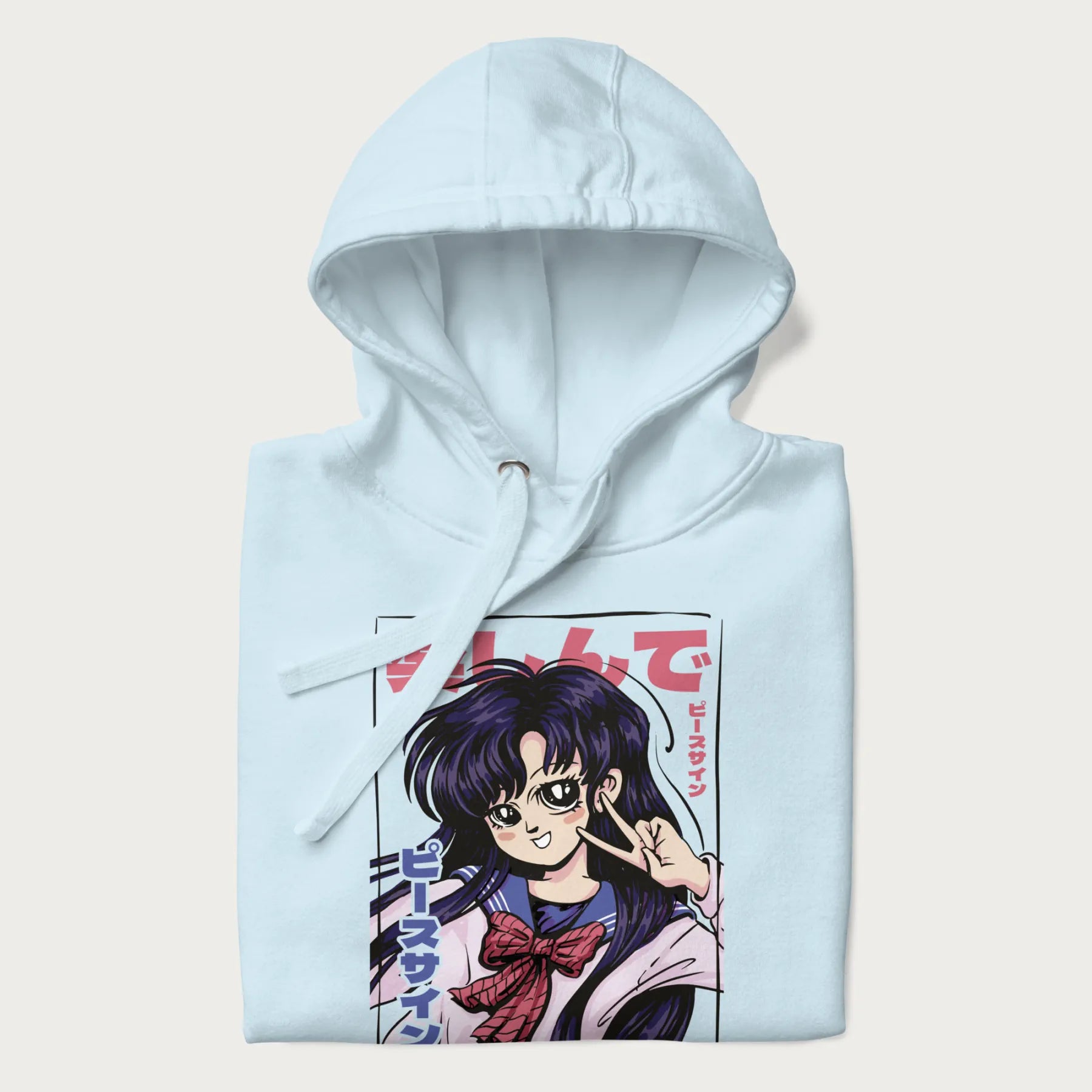 Folded light blue hoodie with Japanese graphic of an anime girl making a peace sign, with Japanese text '楽しんで' (Enjoy) and 'ピースサイン' (Peace Sign).