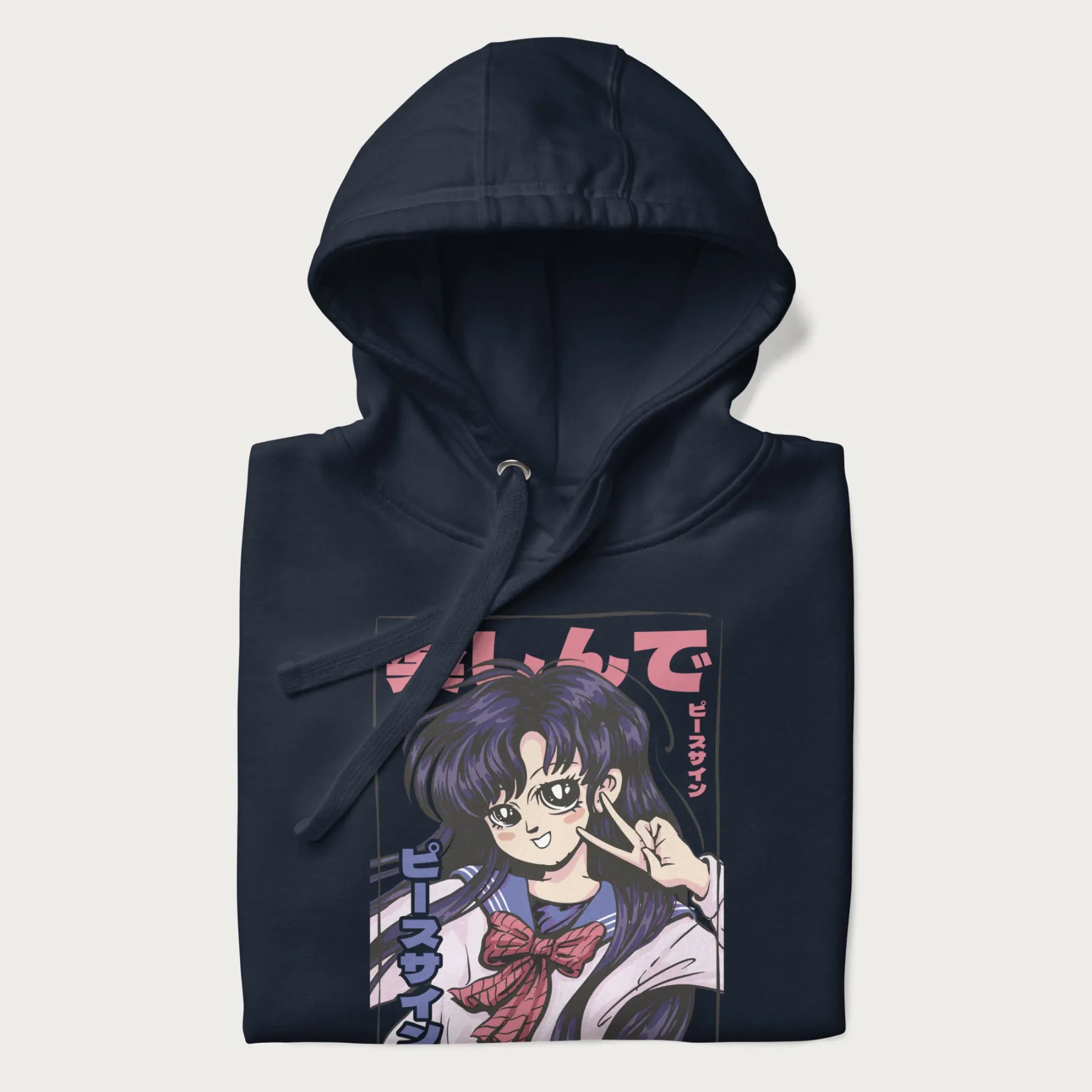 Folded navy blue hoodie with Japanese graphic of an anime girl making a peace sign, with Japanese text '楽しんで' (Enjoy) and 'ピースサイン' (Peace Sign).