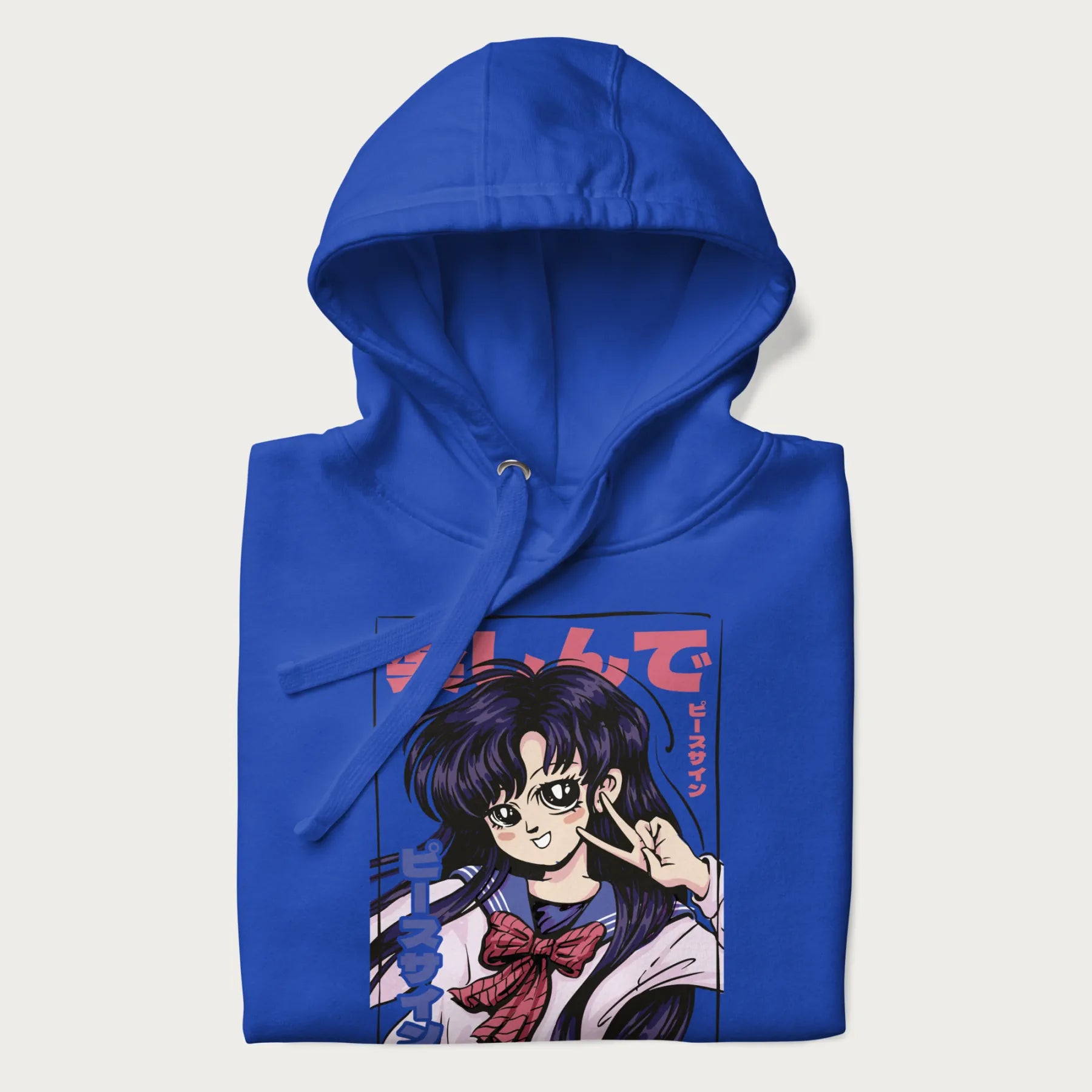 Folded royal blue hoodie with Japanese graphic of an anime girl making a peace sign, with Japanese text '楽しんで' (Enjoy) and 'ピースサイン' (Peace Sign).