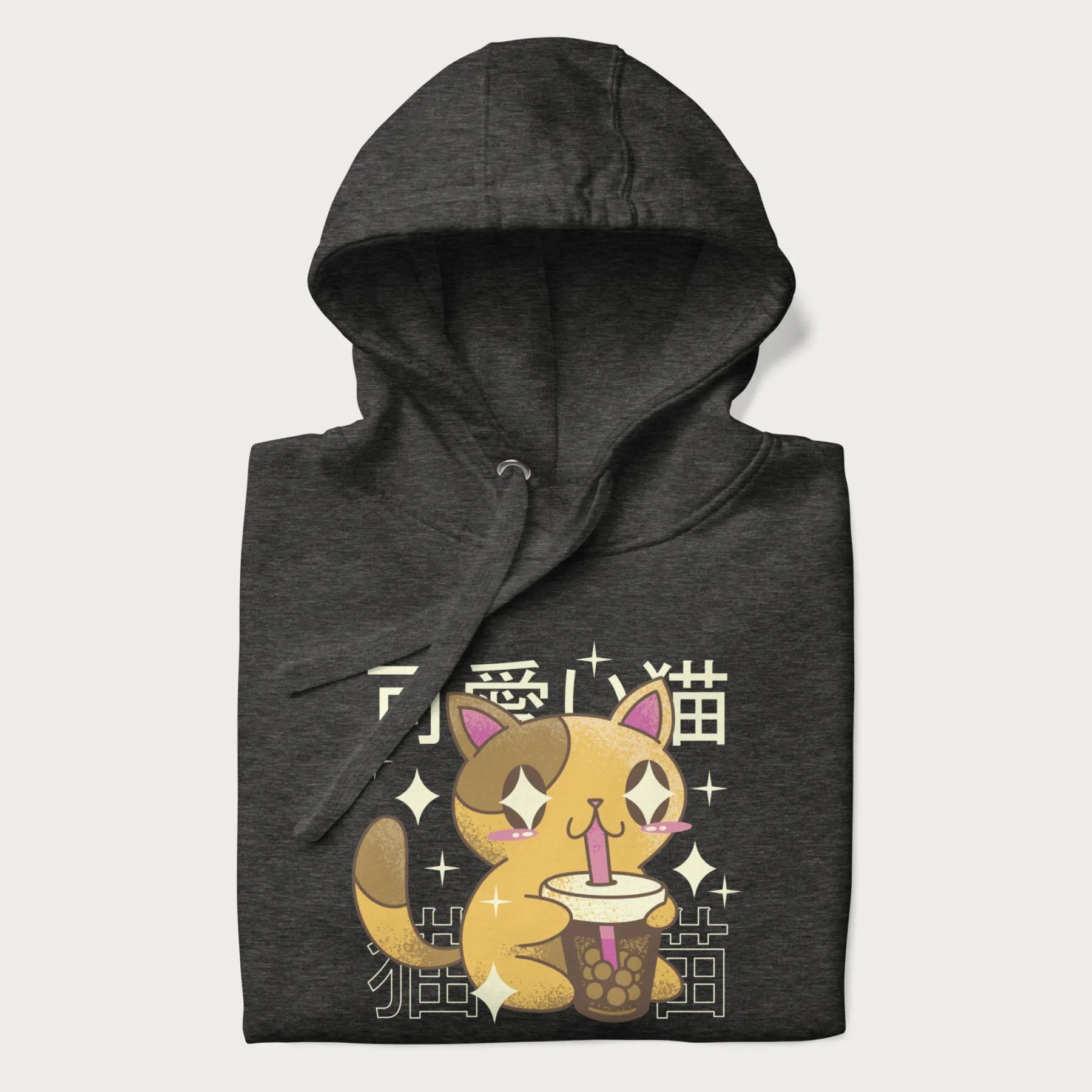 Folded dark grey hoodie with Japanese graphic of a cute yellow cat drinking bubble tea, with the Japanese text '可愛い猫' (Cute Cat) in the background.