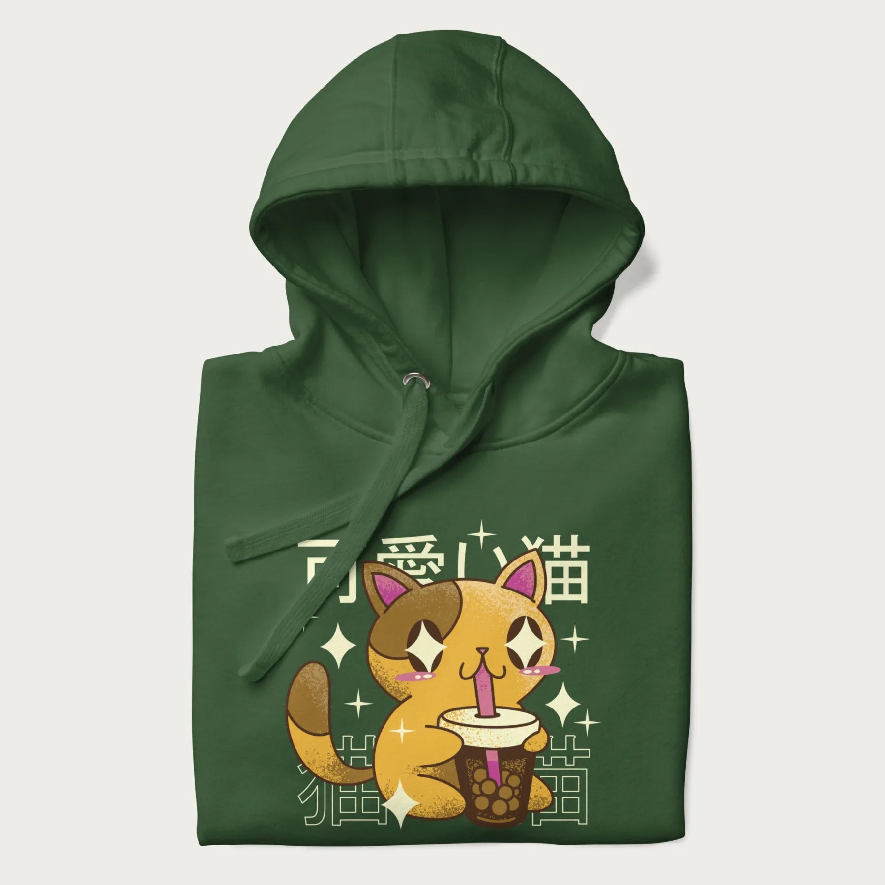 Folded forest green hoodie with Japanese graphic of a cute yellow cat drinking bubble tea, with the Japanese text '可愛い猫' (Cute Cat) in the background.