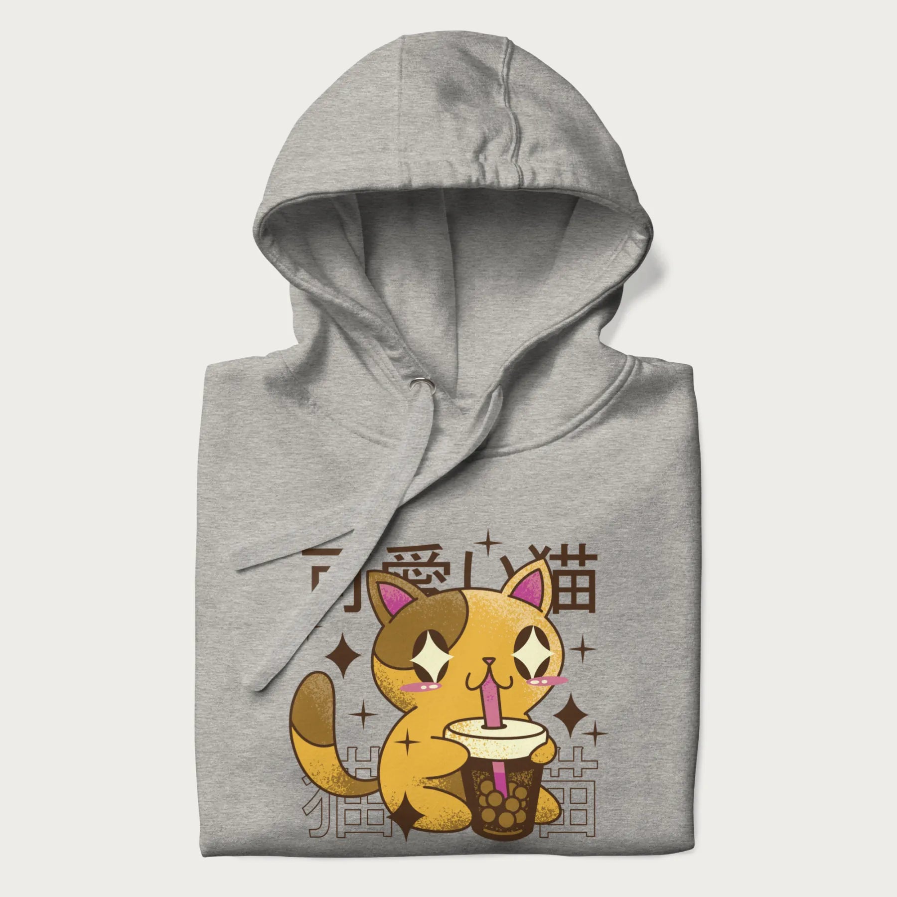 Folded light grey hoodie with Japanese graphic of a cute yellow cat drinking bubble tea, with the Japanese text '可愛い猫' (Cute Cat) in the background.