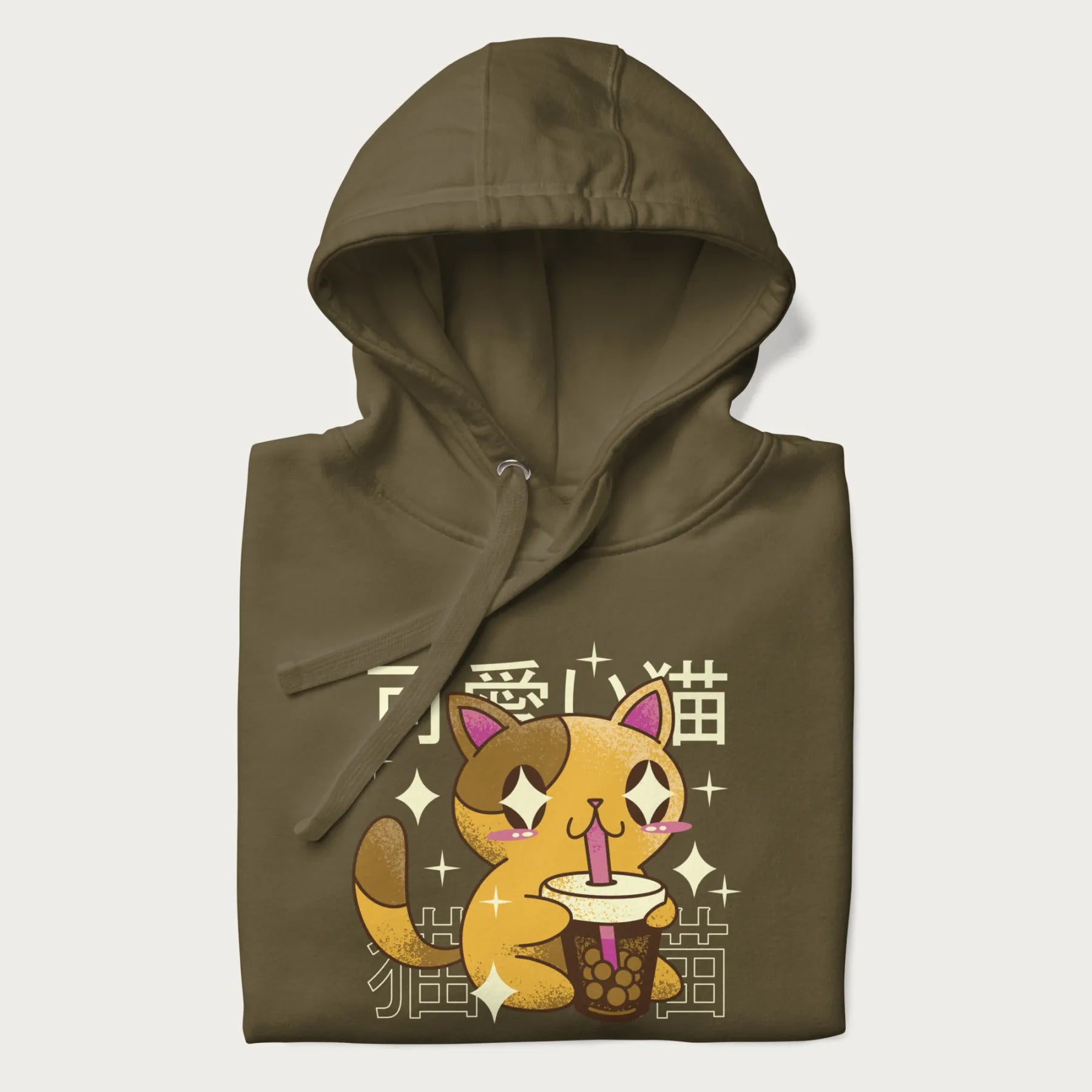 Folded military green hoodie with Japanese graphic of a cute yellow cat drinking bubble tea, with the Japanese text '可愛い猫' (Cute Cat) in the background.